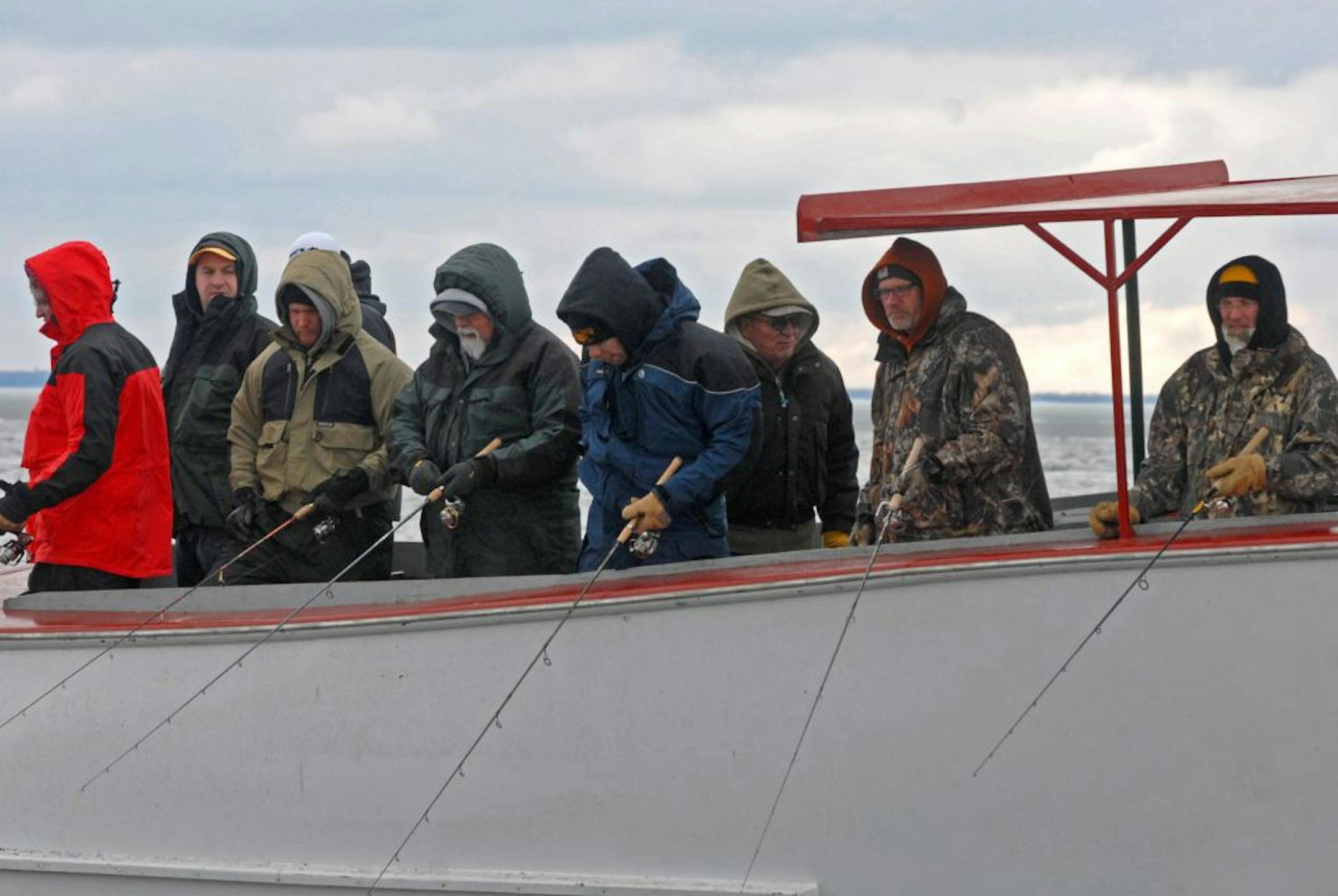 Huddled against the cold while attempting to fool a few walleyes to eat for dinner, these anglers on a Lake Winnibigoshish launch owned by McArdle's Resort tried their luck on opening day Saturday, May 11. Fishing was tough.