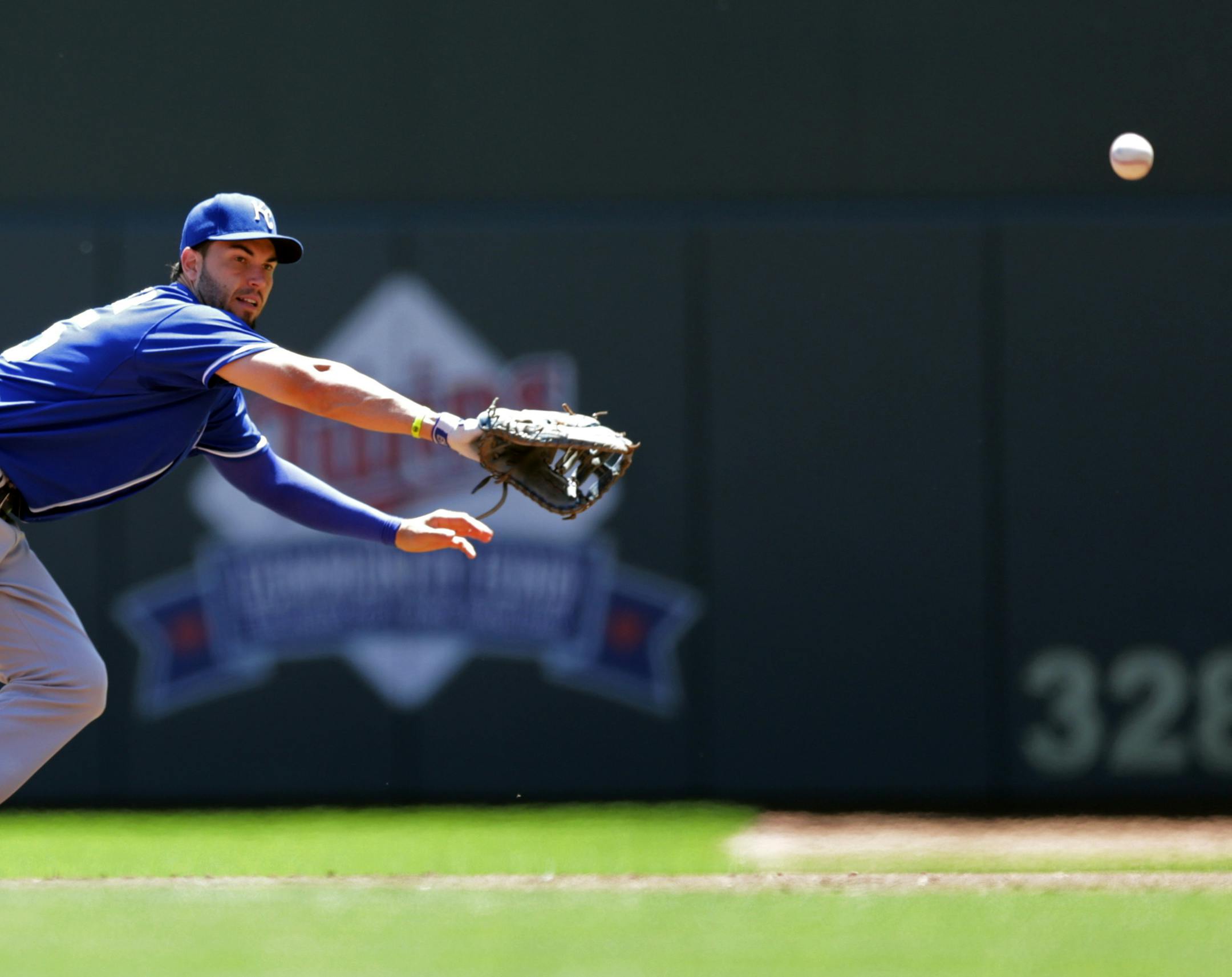 Kansas City Royals first baseman Eric Hosmer can't make the catch as Minnesota Twins' Chris Parmelee singles past him in the first inning of a baseball game, Wednesday, July 3, 2014, in Minneapolis. (AP Photo/Jim Mone)