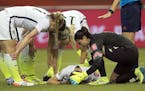 U.S. goalkeeper Hope Solo, right, tends to teammate Morgan Brian, who collided with Germany's Alexandra Popp during the first half of a semifinal in t