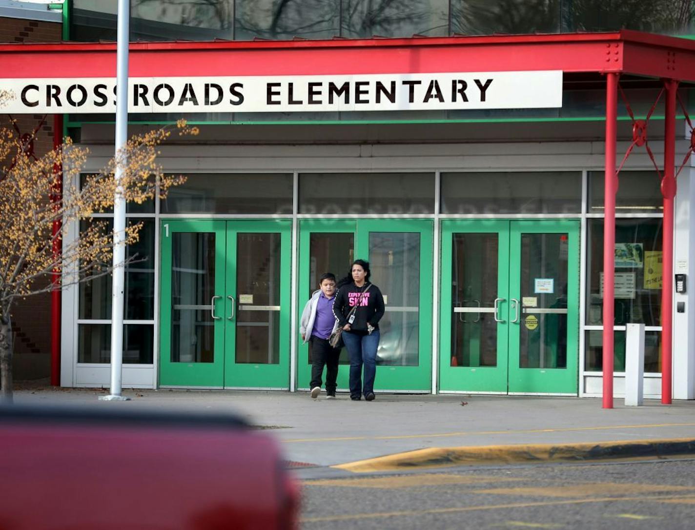 A loaded handgun brought to Crossroads Elementary School by a seven-year-old first grade student discharged one round but no one was hurt Thursday, Nov. 17, 2016, in St. Paul, MN. Here, parents pick up their children from the school Thursday afternoon.