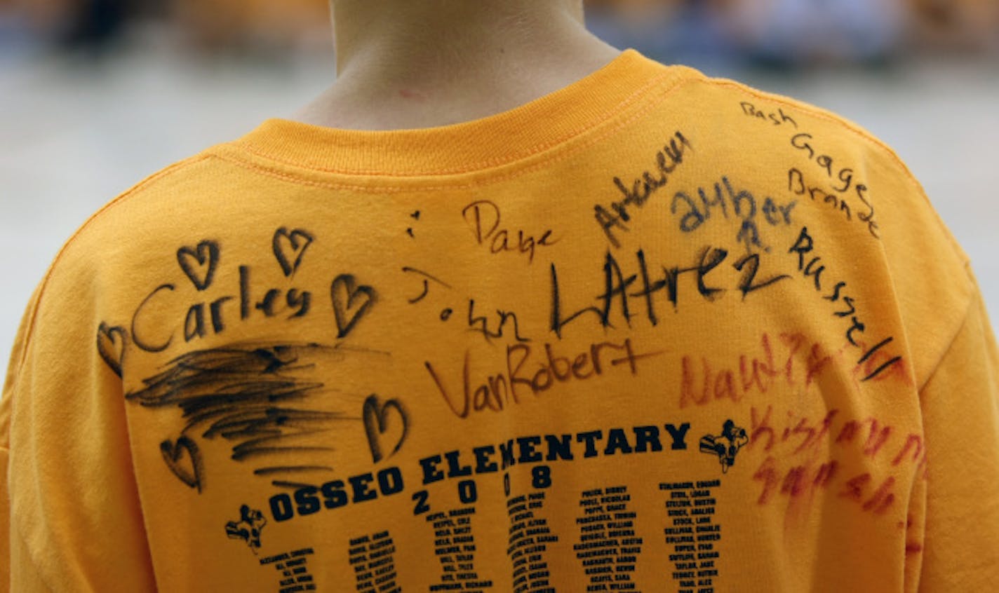 Students personalized each others' T-shirts, which featured all the names of the school's students on the back. Many friends will be split up by the move, which will see kids going to several different schools next fall.