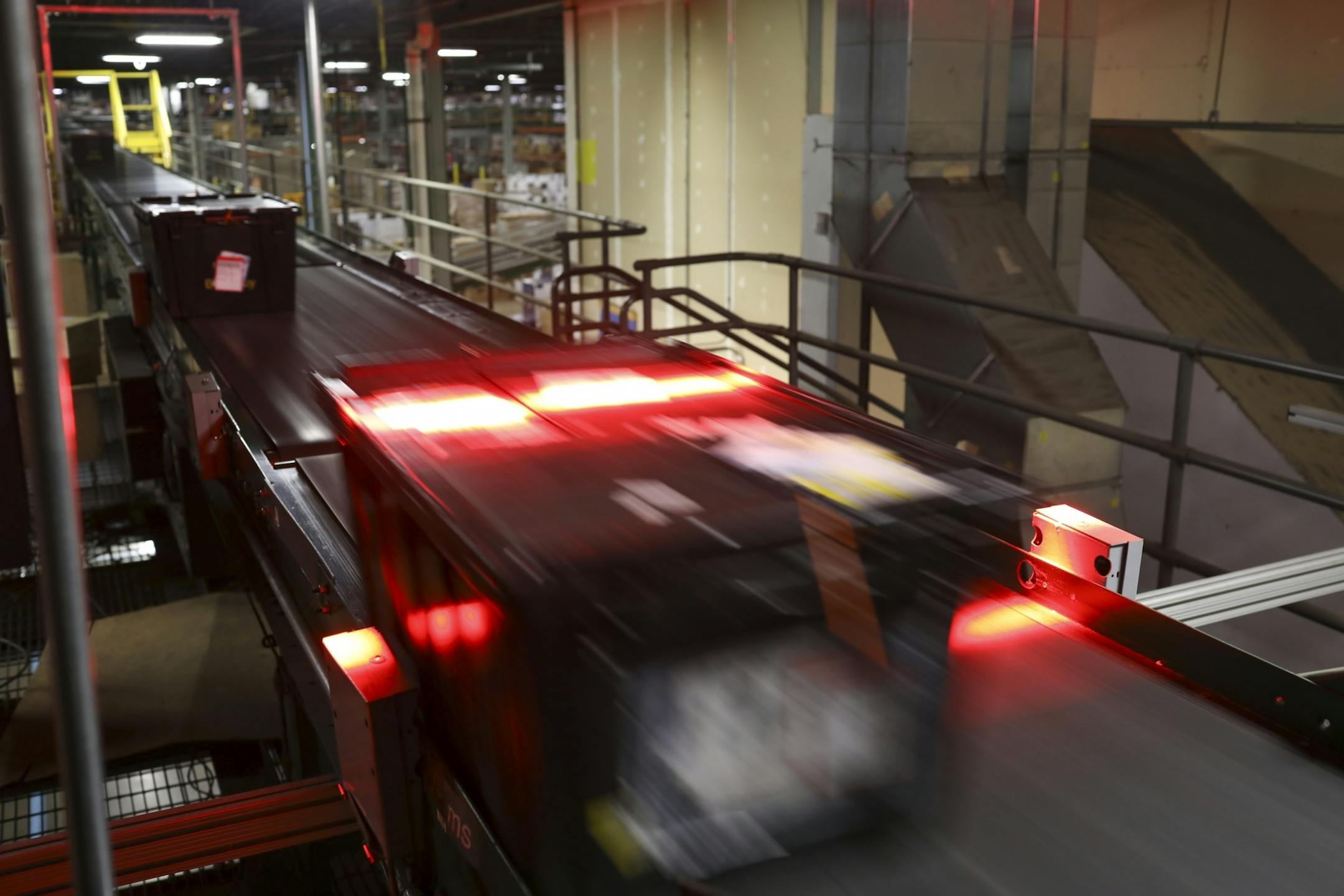 Shipping crates of items were scanned as they moved on a conveyer belt towards a waiting semi-trailer for transport from the Best Buy distribution center in Bloomington.