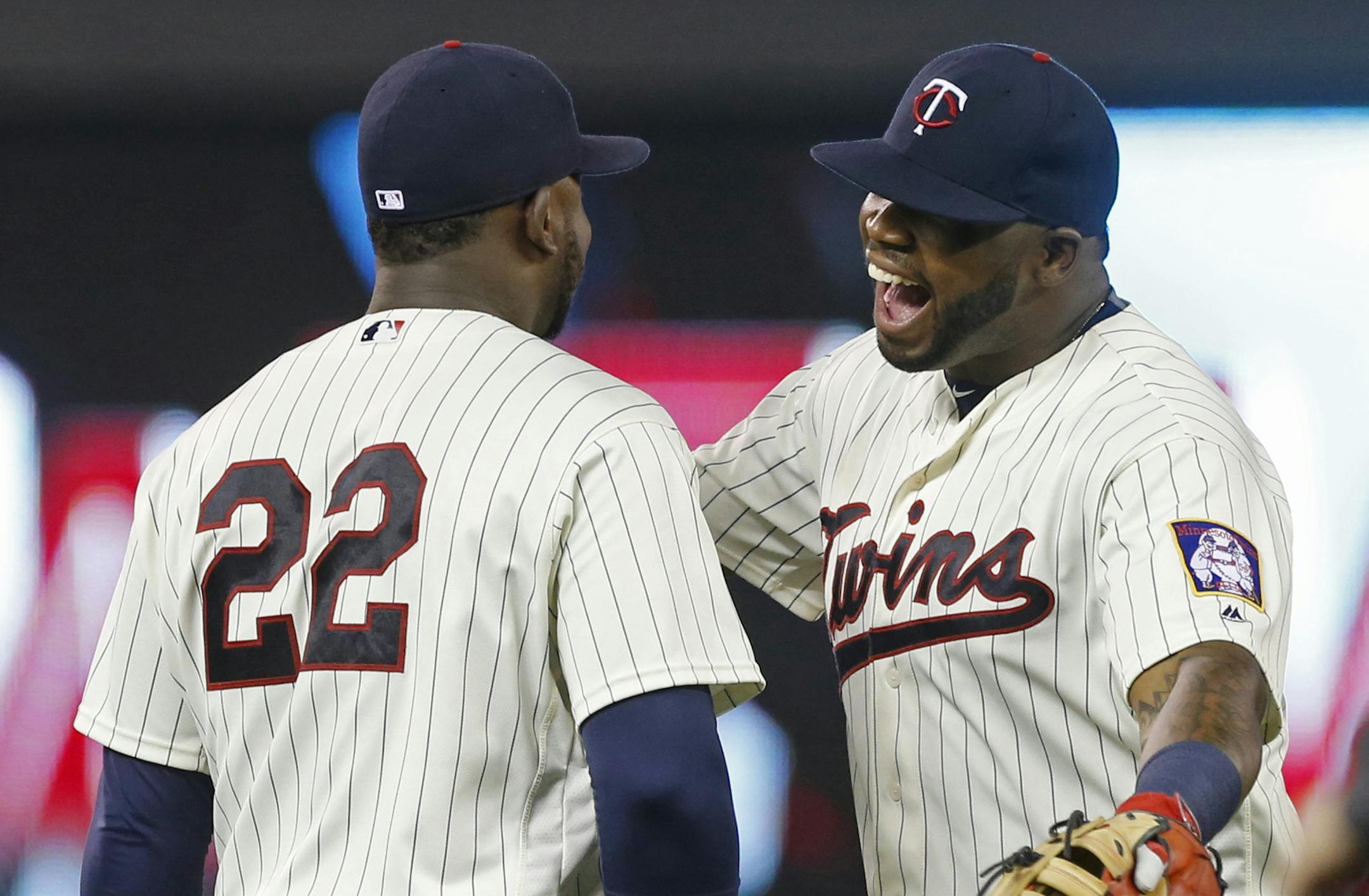 Minnesota Twins' Kennys Vargas, right, and Miguel Sano celebrate the Twins win over the Seattle Mariners in a baseball game Saturday, Sept. 24, 2016, in Minneapolis. Sano hit the go-ahead run with a solo home run in the fourth inning. (AP Photo/Jim Mone)