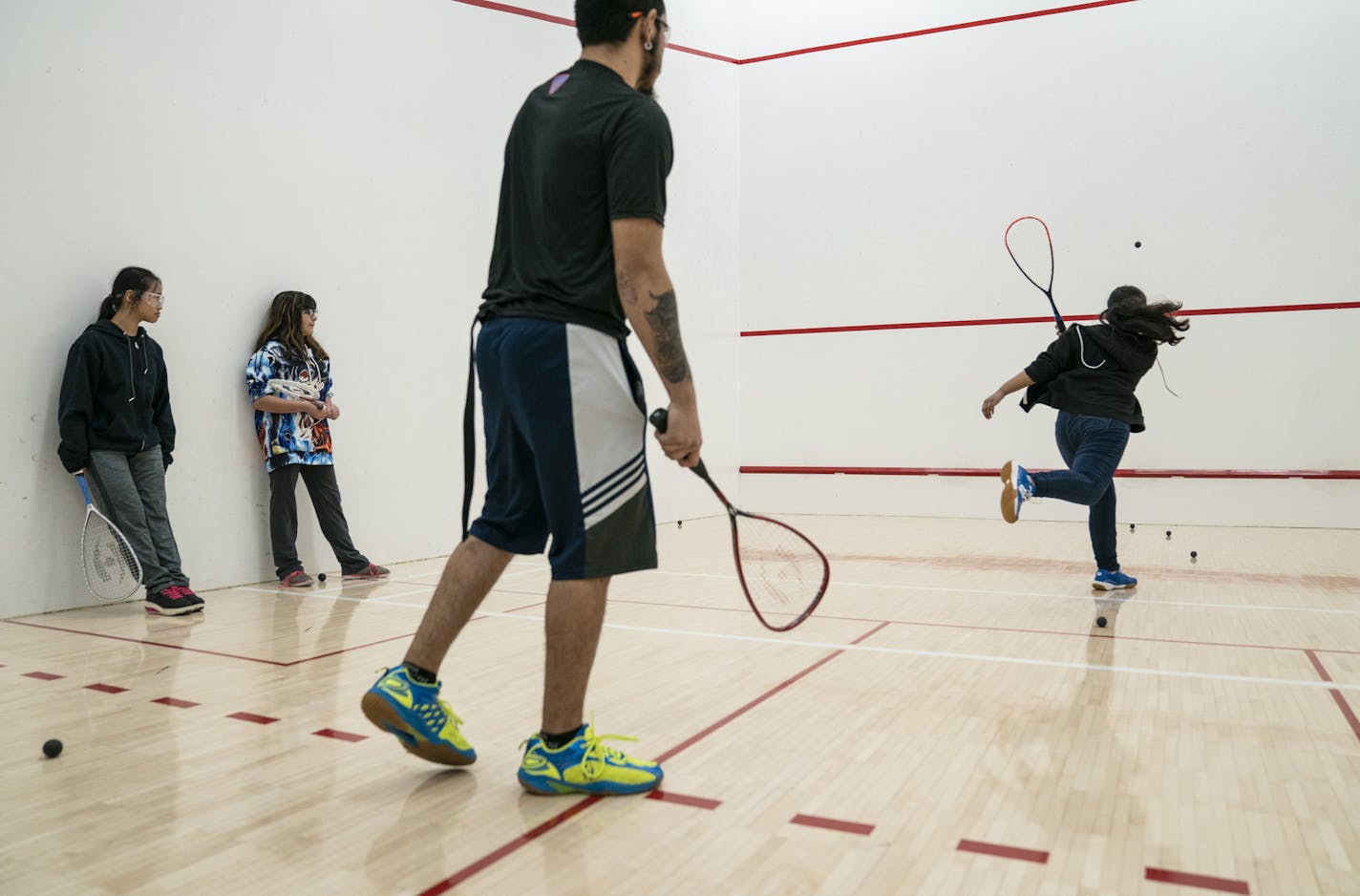 Coach and alum go the Beyond Walls program Jesus Viveros, center, coached students (from the left) Mya Nay Paw, 12, Vanessa Diaz,13, and Alina Hong,12, during a Beyond Walls Urban Squash Twin Cities practice at the University of Minnesota in Minneapolis, Minn., on Wednesday, January 23, 2019. ] RENEE JONES SCHNEIDER &#xa5; renee.jones@startribune.com