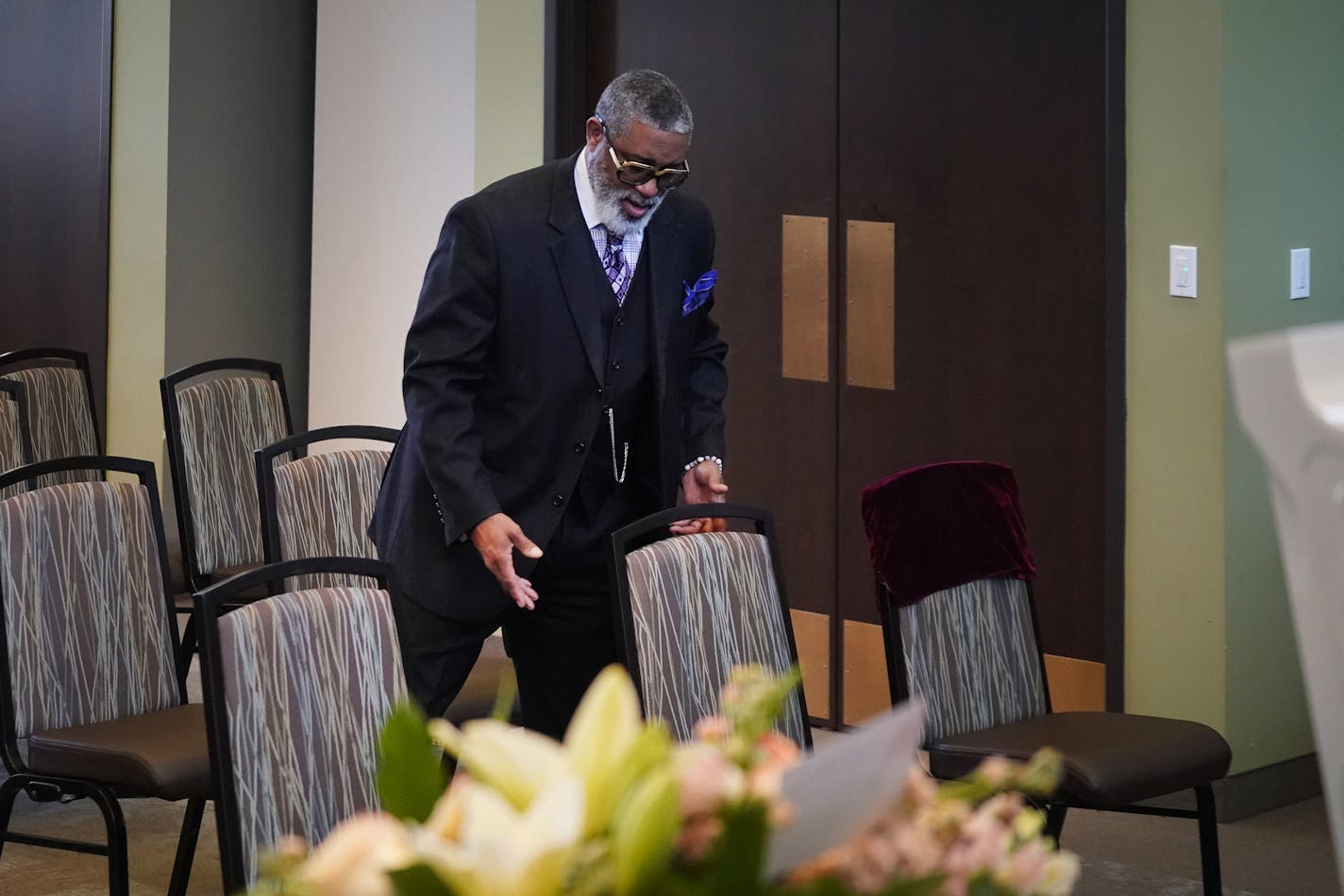 Estes Funeral Chapel CEO and licensed funeral director Tracy Wesley, Sr. arranged chairs to add distance between memorial attendees before a service. Estes, in Minneapolis, is taking extra precautions during the COVID-19 breakout, including extra cleaning between memorial services.