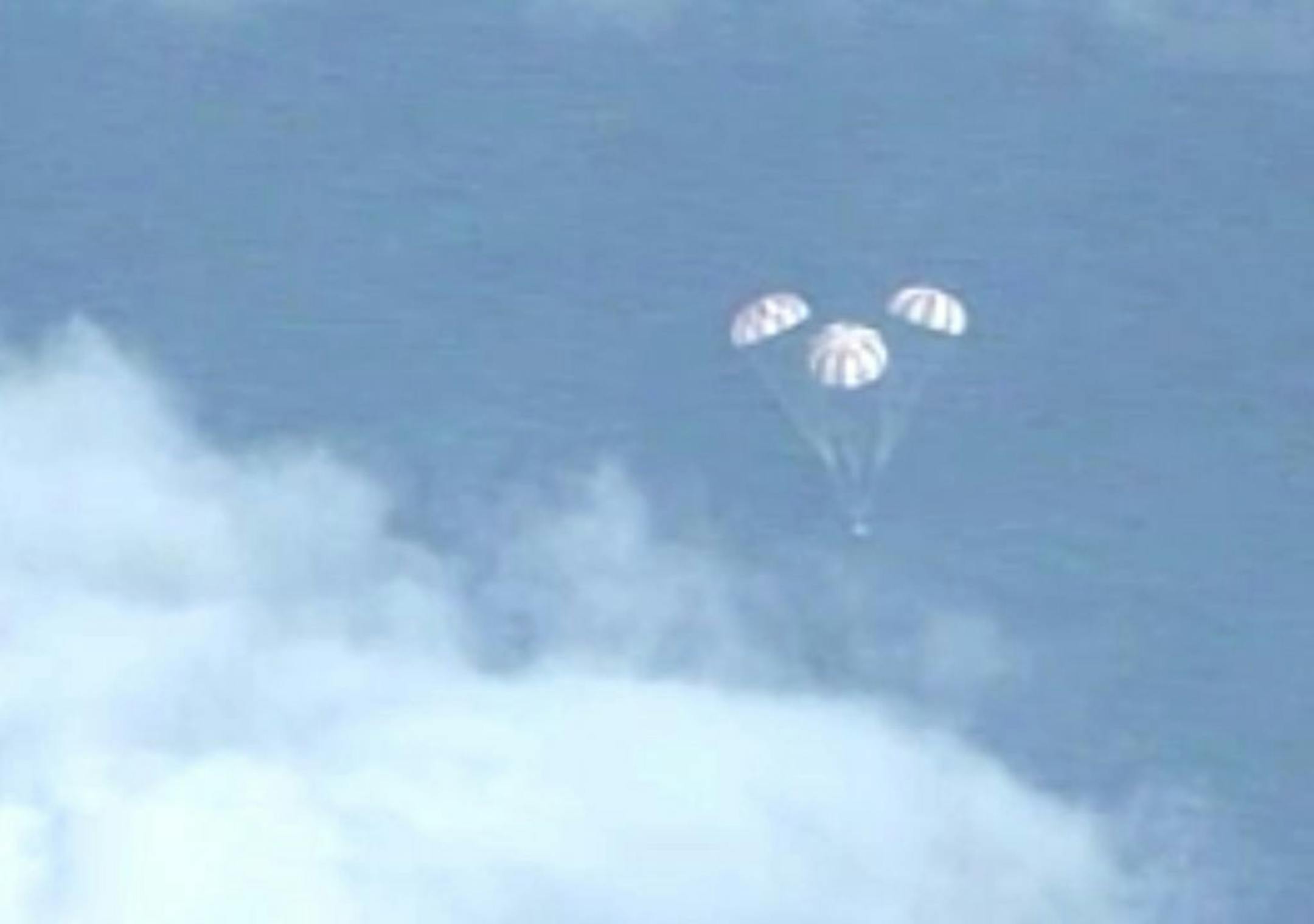 In this frame grab from NASA-TV, the Orion spacecraft descends before splashing down in the Pacific Ocean, Friday, Dec. 5, 2014, following a dramatic test flight that took it to a zenith height of 3,600 miles and ushered in a new era of human exploration aiming for Mars.