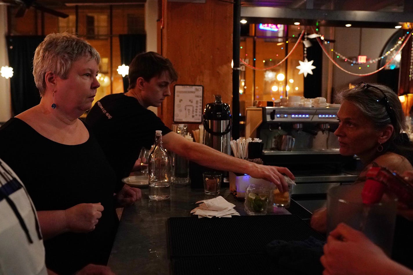 Co-owner Sara Remke, left, spoke with bartender Eli Nielsen, right, Saturday evening at the Black Dog Cafe. ] ANTHONY SOUFFLE &#x2022; anthony.souffle@startribune.com Patrons came for food, drinks, and jazz Saturday, Dec. 22, 2018 at the Black Dog Cafe in St. Paul, Minn. The cafe turns 20 on Dec. 27th.