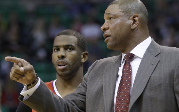 Los Angeles Clippers' head coach Doc Rivers speaks with Los Angeles Clippers' Chris Paul (3) in the first quarter during an NBA basketball game agains