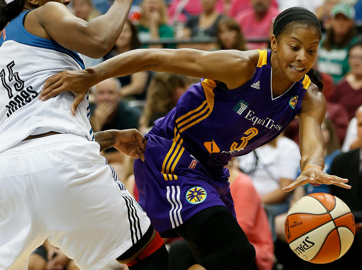 Los Angeles Sparks star Candace Parker dribbled around Lynx forward Asjha Jones when the Lynx and Sparks played on July 29.