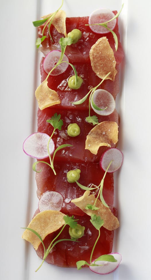 Raw yellowfin tuna, dressed with radishes, avocado and flaky sea salt.