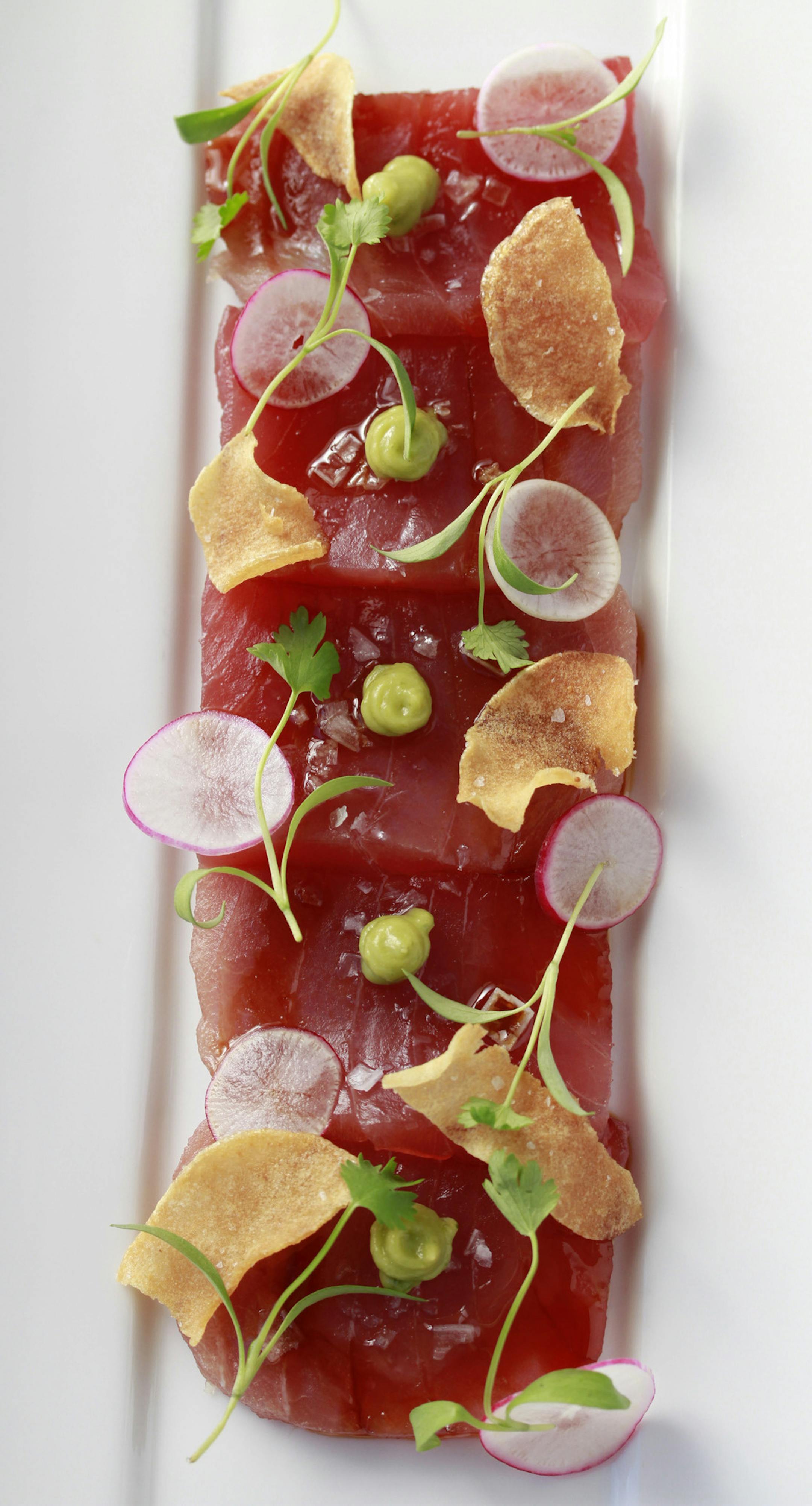 Raw yellowfin tuna, dressed with radishes, avocado and flaky sea salt.