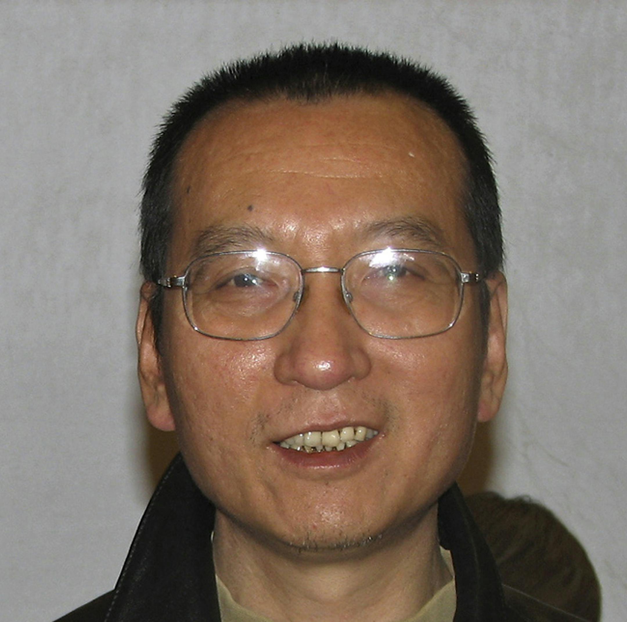 FILE - In this November 2007 photo released by Liu Xiaobo's friend on Oct. 8, 2010, Liu poses during a gathering in Beijing. More than 100 Chinese activists have signed and released an open letter asking that Nobel Peace Prize winner Liu Xiaobo be released from prison. The letter released late Thursday Oct. 14, 2010, and posted online also asks China's leaders to respond to the peace prize "with realism and reason." (AP Photo/File) ** CHINA OUT **