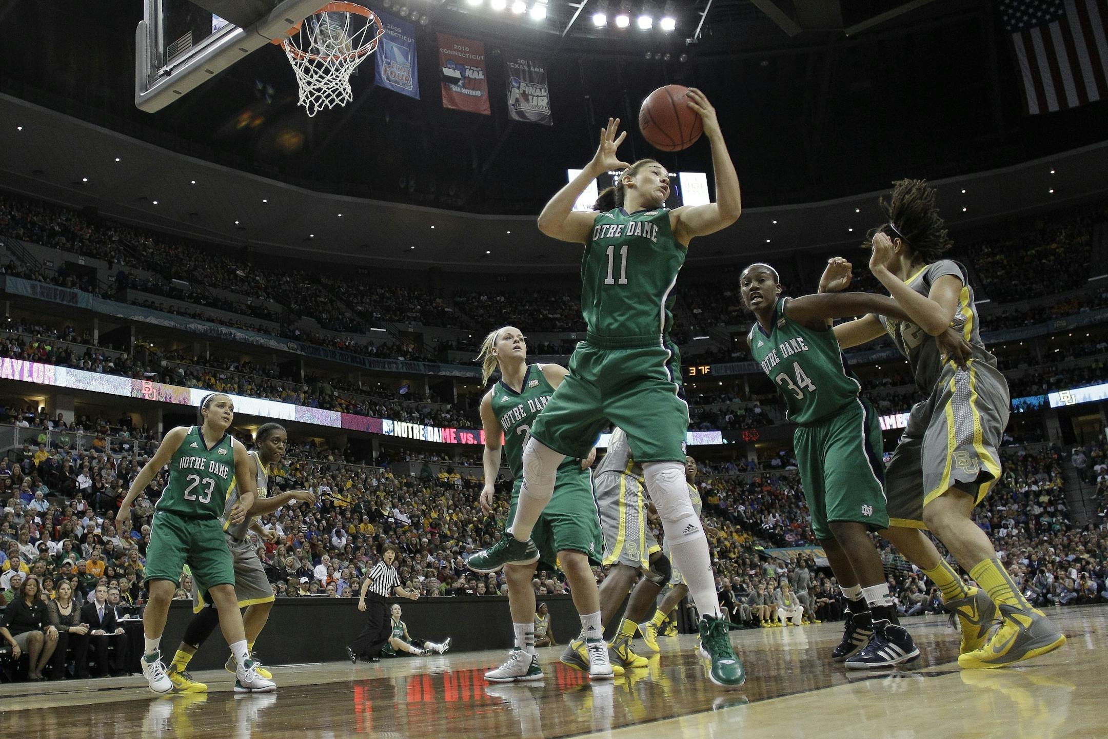 Notre Dame forward Natalie Achonwa (11) pulls in a rebound during the first half in the NCAA Women's Final Four college basketball championship game against the Baylor, in Denver, Tuesday, April 3, 2012.