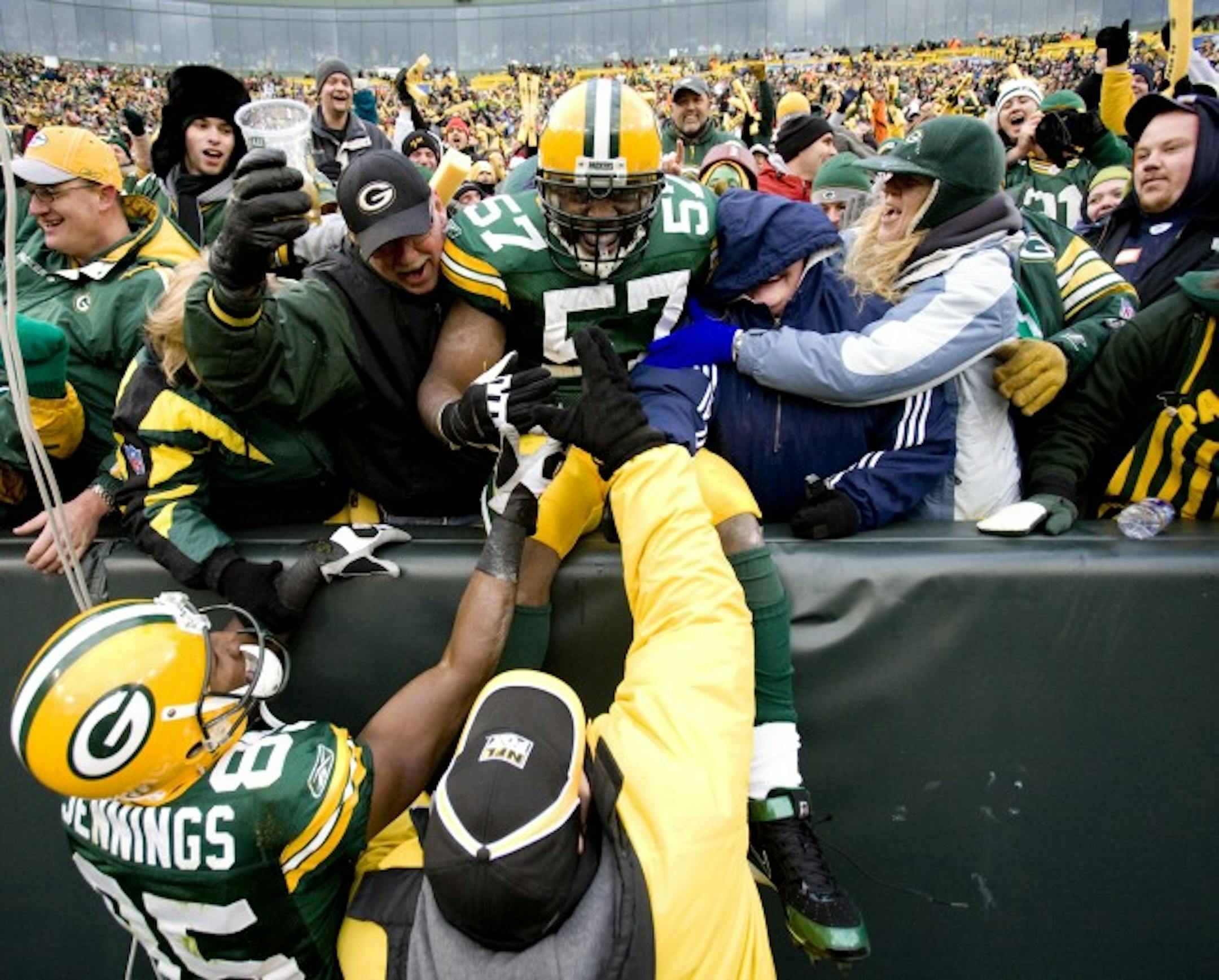 Green Bay Packers' Jason Hunter celebrated with the crowd after returning a fumble 54 yards for a touchdown during the second half Sunday.