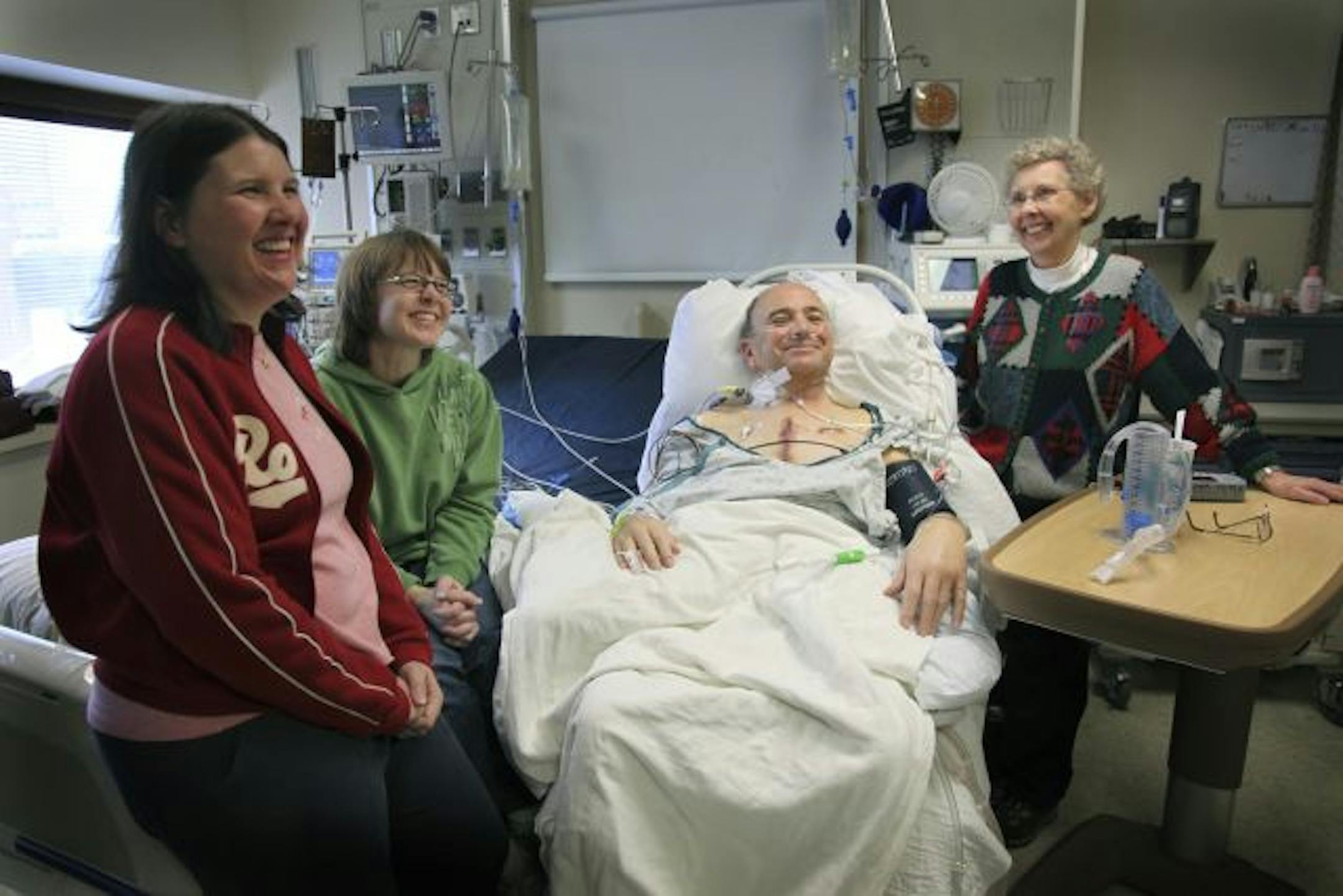 Karin Hagen, left, and Kirsten Head, center, were all smiles and filled with happiness as they comforted their parents Don and Carolyn Weber at Fairview University Hospital.