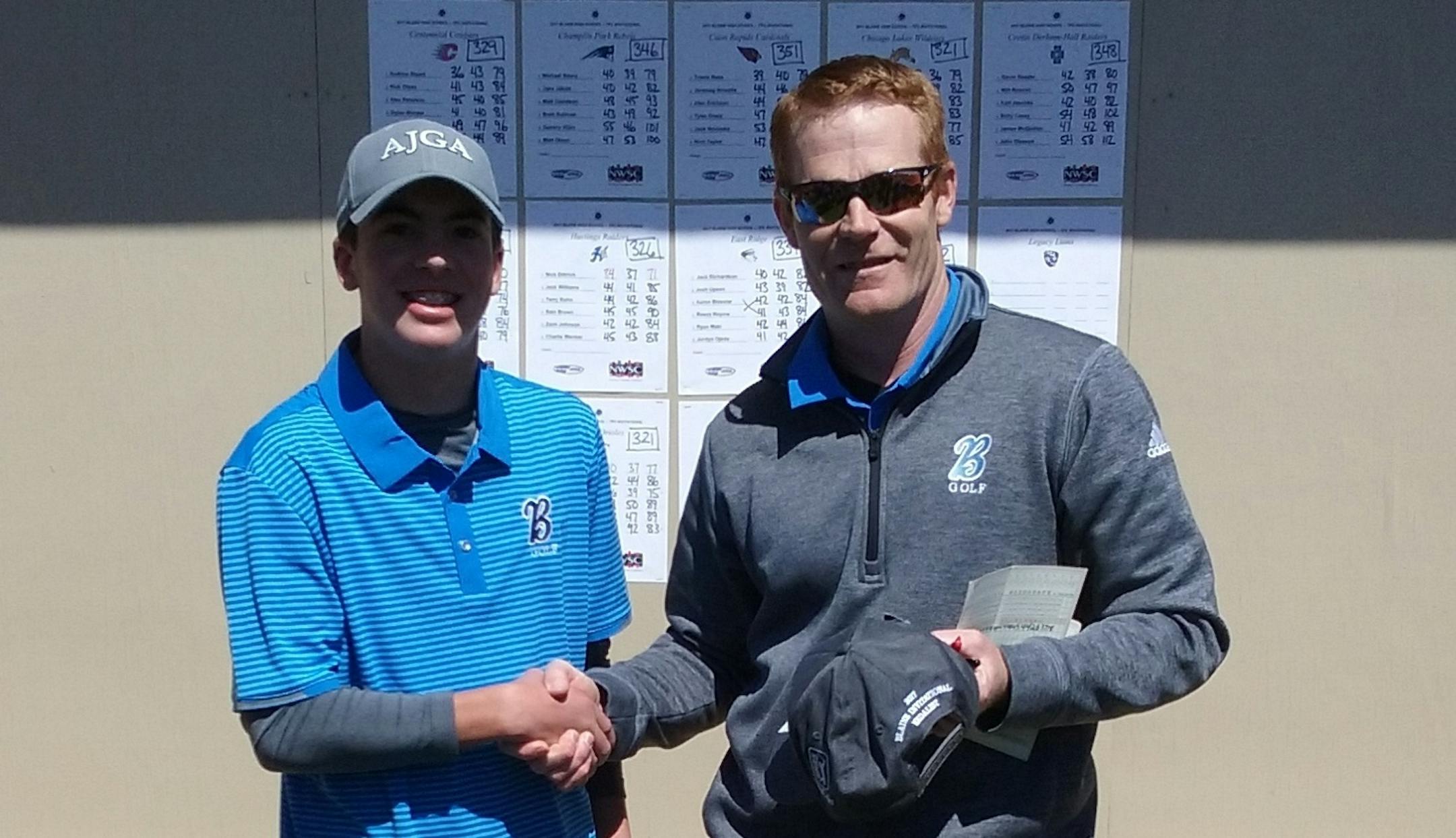 Blaine sophomore Caleb VanArragon and coach Kevin Overgaard after VanArragon shot what is believed to be a boys' state-record round of 63 on April 17 at TPC Twin Cities.