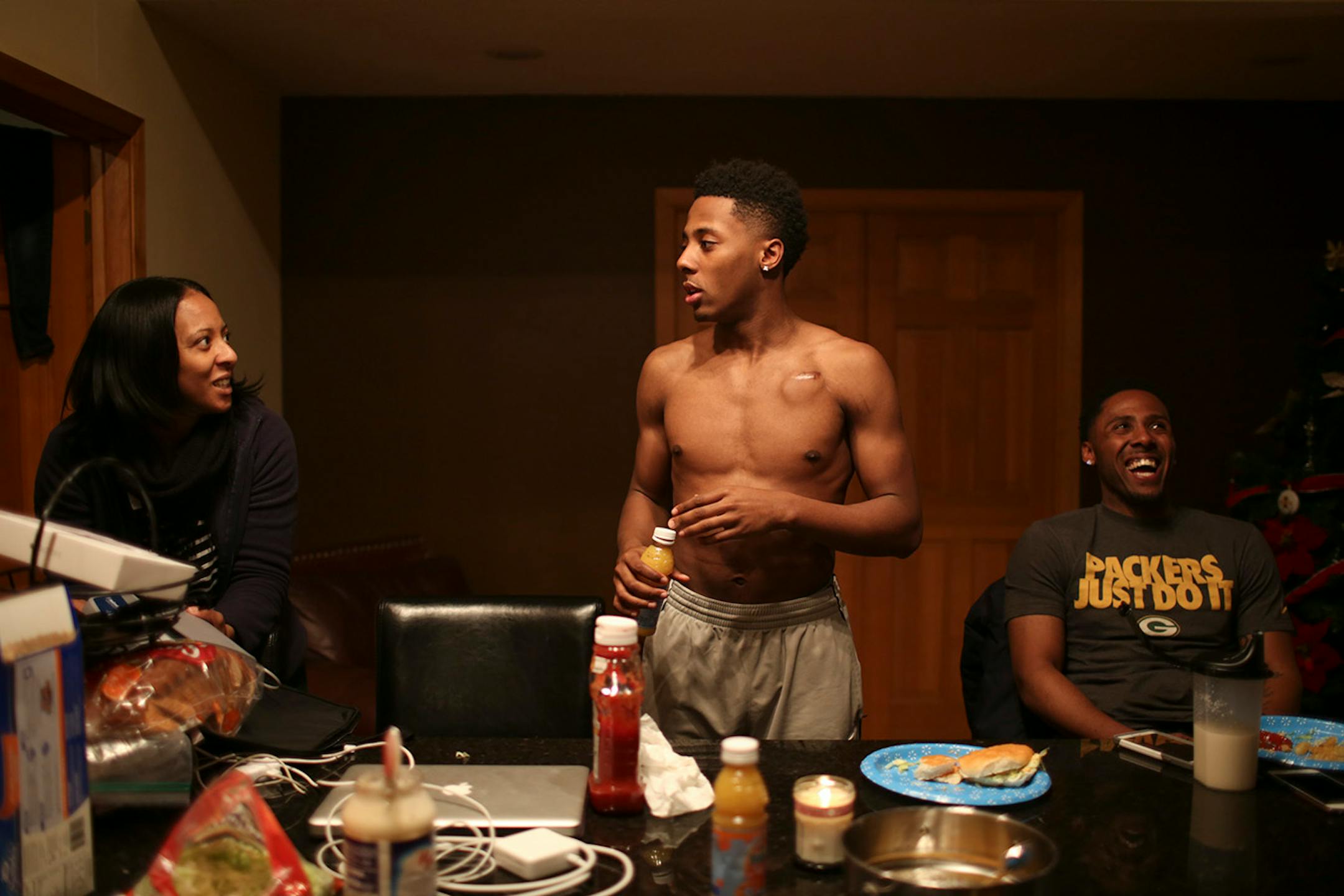Jarvis Johnson with his mom, Tanisha and his older brother, Ty, at his family's Brooklyn Park home. ] JEFF WHEELER • jeff.wheeler@startribune.com Jarvis Johnson, the DeLaSalle player who is the state's top basketball recruit, should be dead. His heart stopped for 12 minutes at the beginning of a practice when he was an eighth grader. Now with a defibrillator implanted in his chest, he's committed to the University of Minnesota. He was photographed at his family's Brooklyn Park home Thursday even