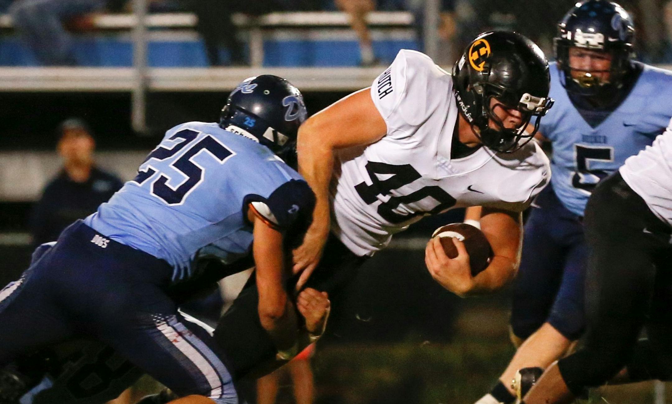 Hutchinson quarterback Russell Corrigan dives forward for extra yardage against Becker Friday night. Corrigan scored both TDs in the Tigers’ 16-13 victory over the Bulldogs at Eppard Field in Becker. Photo by Jeff Lawler, SportsEngine