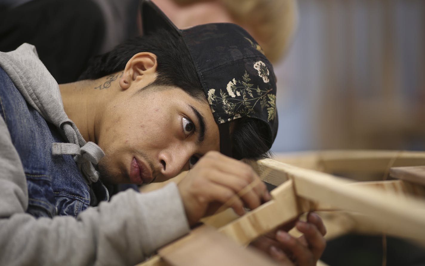 Joseph Romero and other apprentices worked on the kayak built for Give to the Max Day at Urban Boatbuilders in St. Paul.