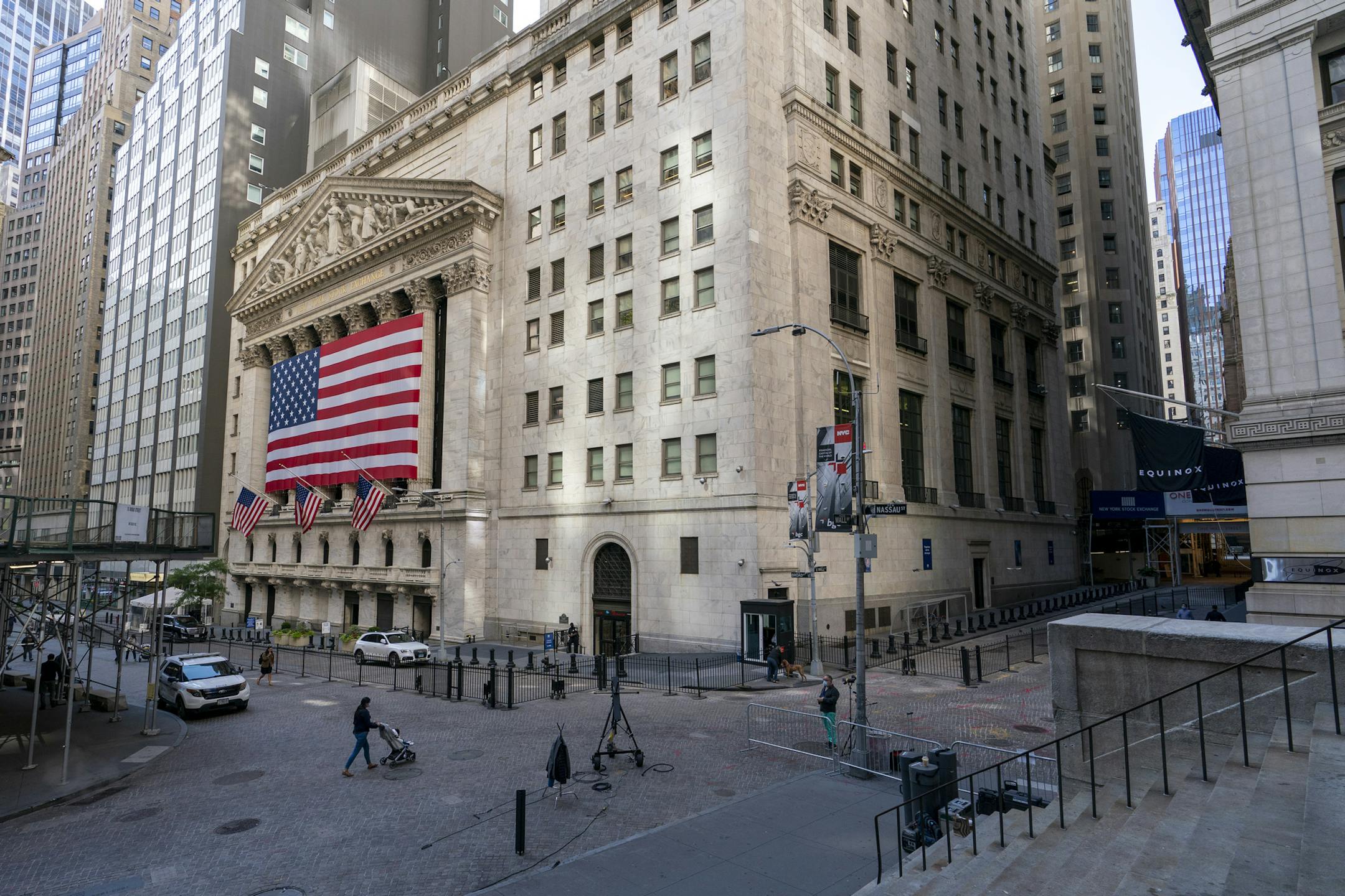 FILE - In this Monday, Sept. 21, 2020 file photo, a giant American Flag hangs on the New York Stock Exchange. Wall Street is rallying Wednesday, Sept. 30 on rising hopes that Washington may pierce through its paralyzing partisanship to offer more aid for the economy. (AP Photo/Mary Altaffer, File) ORG XMIT: NYBZ701