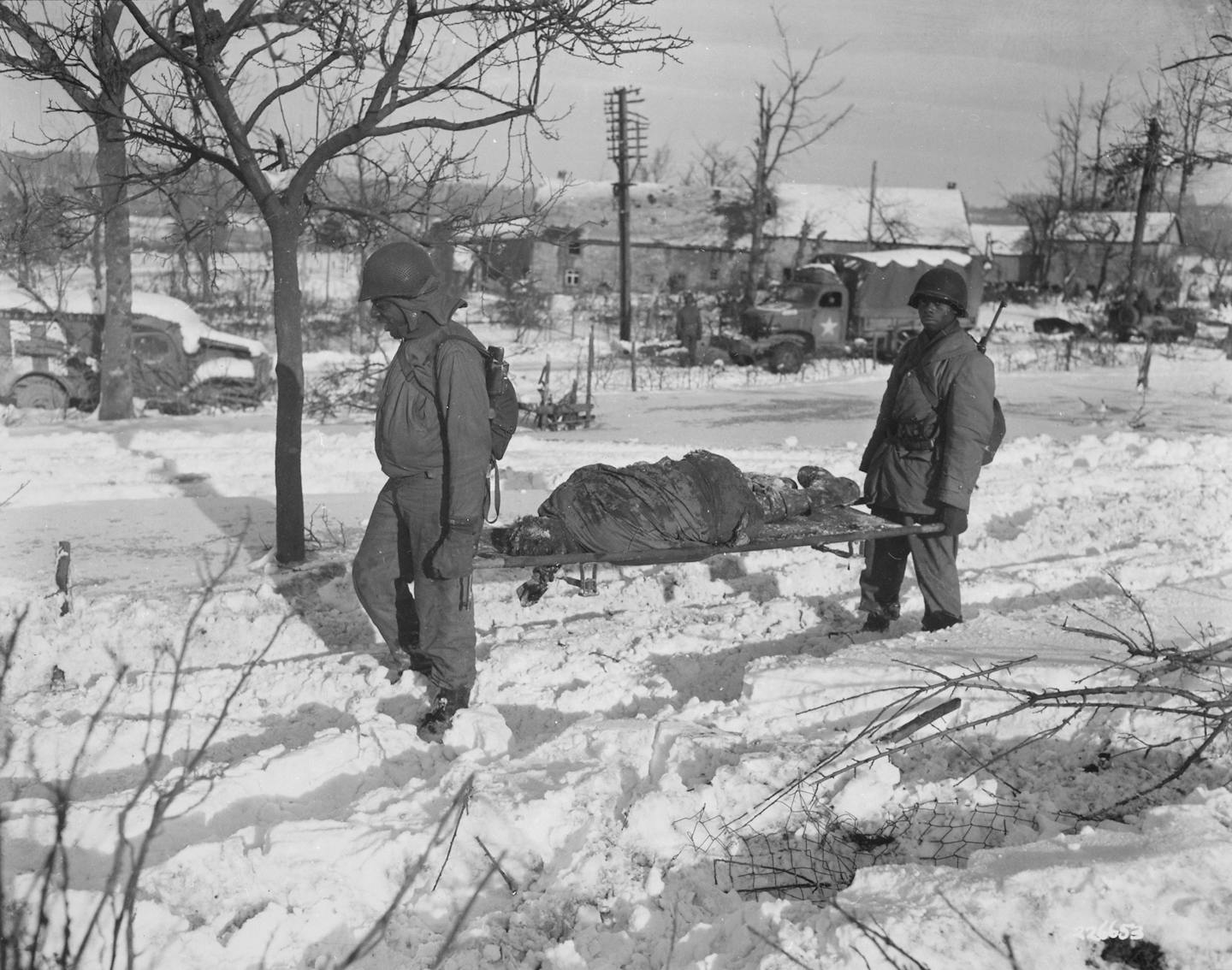 Image of MALMEDY MASSACRE, 1944 American soldiers recovering the bodies of  their