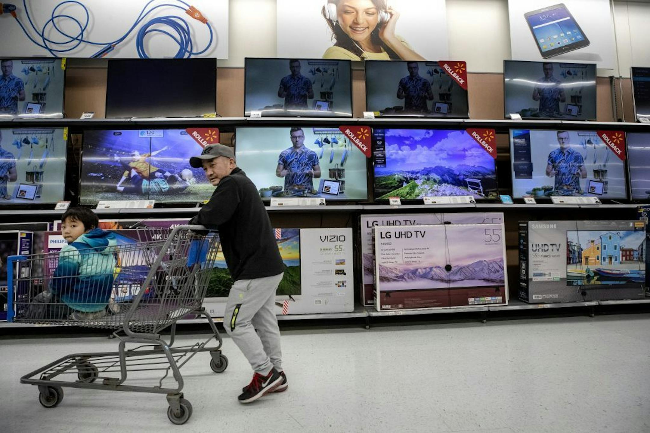 Steve Vang and his son Justice, 5, shopped in the electronics department at Walmart on Fridley.