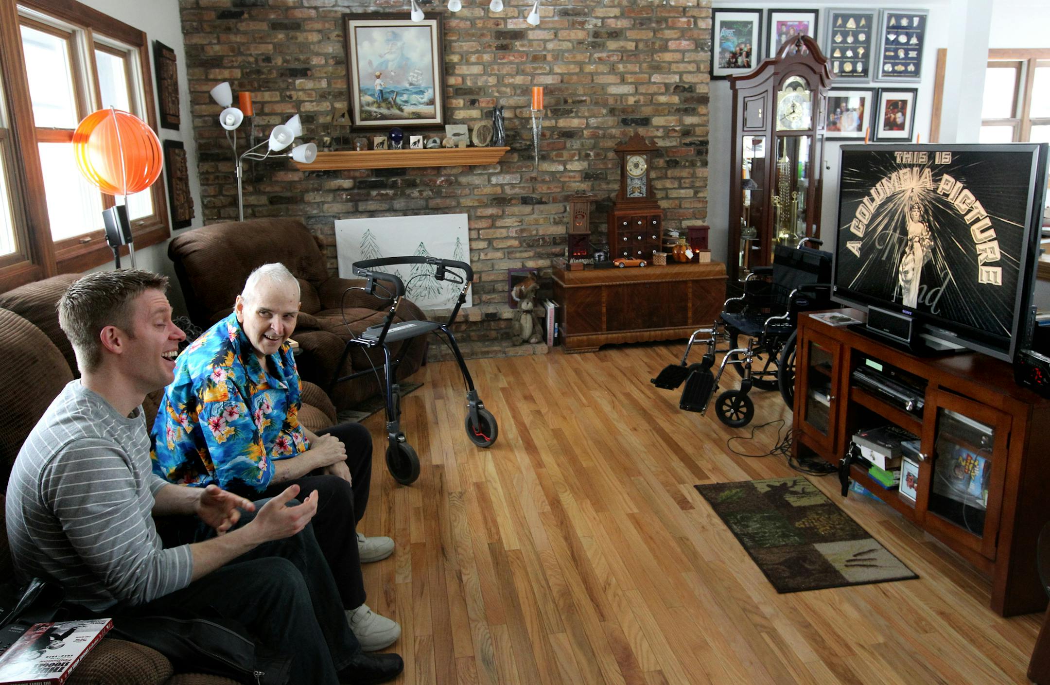 Hospice volunteer, Rick Rasmussen visits Bob Nell every week for a bit of conversation and a episode or two of the Three Stooges which they both love. Bob has liver cancer and actually has been in hospice for almost two years and the two have developed a strong relationship though the hospice care system. [ TOM WALLACE - twallace@startribune.com Assignments #20027721A March 17, 2013 SLUG: 296553 Hospice032413 EXTRA INFORMATION: volunteering to work with people in hospice care, you are entering w