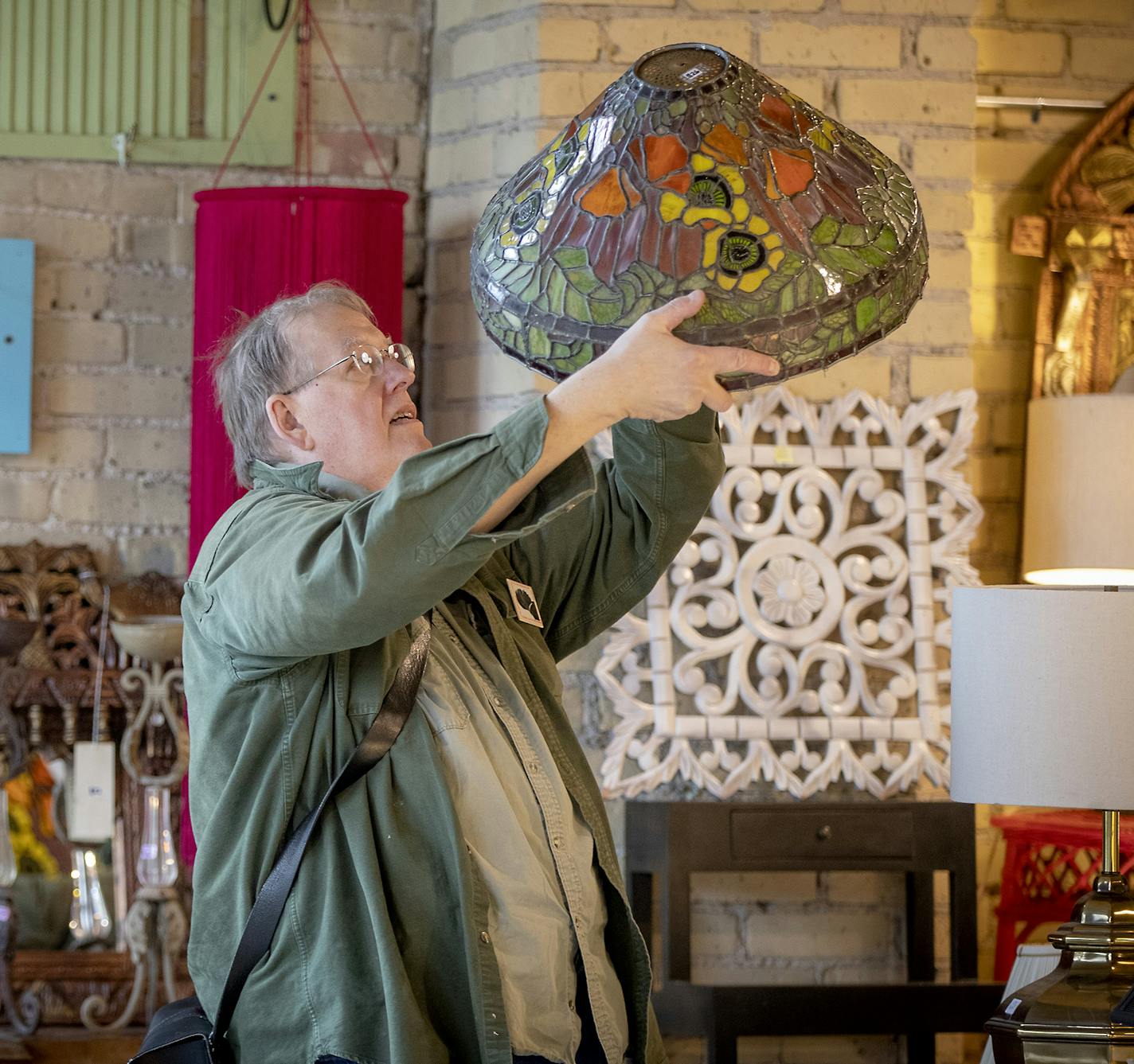 Bill Lowrie, took a closer look at a lamp shade while he shopped and donated at the Old School Steeple People's new location, Friday, October 26, 2018 in Minneapolis, MN. The popular store had to close last year after their building was being razed for redevelopment. ] ELIZABETH FLORES &#xef; liz.flores@startribune.com