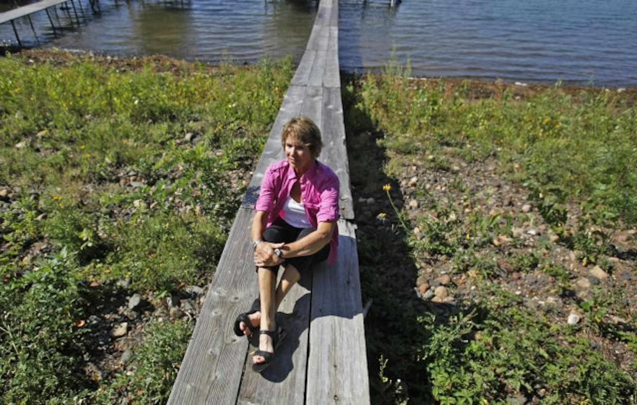Mary Rondeau Westra sits on the family's dock alongside White Bear Lake, where the family spread Peter's ashes.