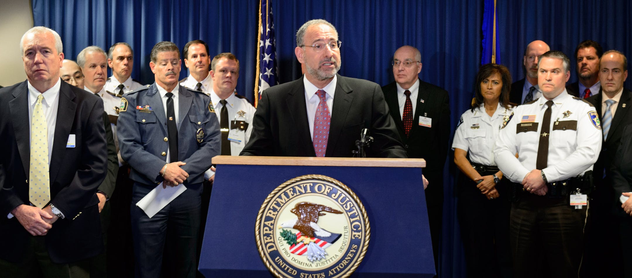 Surrounded by local law enforcement leaders, U.S. Attorney Andrew Luger talked about the statewide crackdown on heroin dealers. At left is Jack Riley, in charge of Drug Enforcement Administration efforts in Minnesota and four other states. The sweep led to 65 arrests.