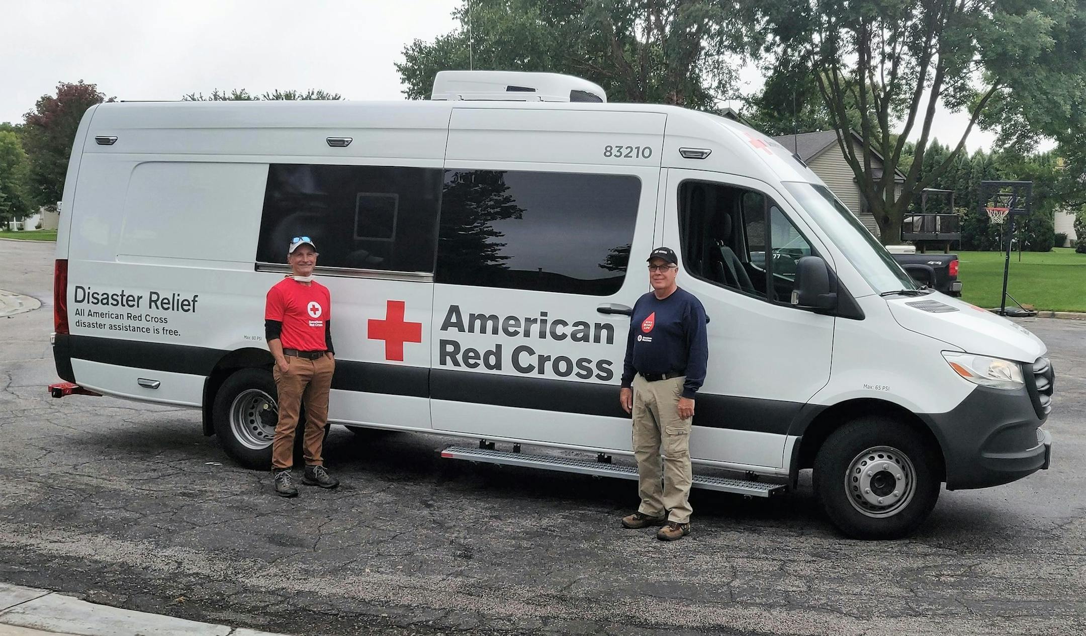 Red Cross volunteers Matthew Hoffman of Mahtomedi (left) and James Carlin of Sauk Rapids (right) leave in an Emergency Response Vehicle to bring meals, clean-up kits and other supplies to those cleaning up after the West Coast wildfires.