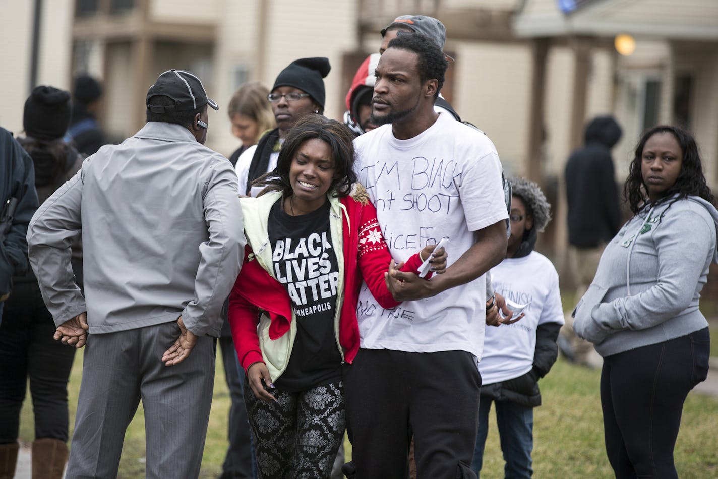 Joyce Powell, a relative of Jamar Clark, is comforted by Tyrus Forrest on Wednesday, March 30, 2016, near the site where Jamar Clark was shot by Minneapolis police. Hennepin County Attorney Mike Freeman announced Wednesday that no charges will be filed against the two officers involved in the shooting death of Clark. (Leila Navidi/Minneapolis Star Tribune/TNS) ORG XMIT: 1182652