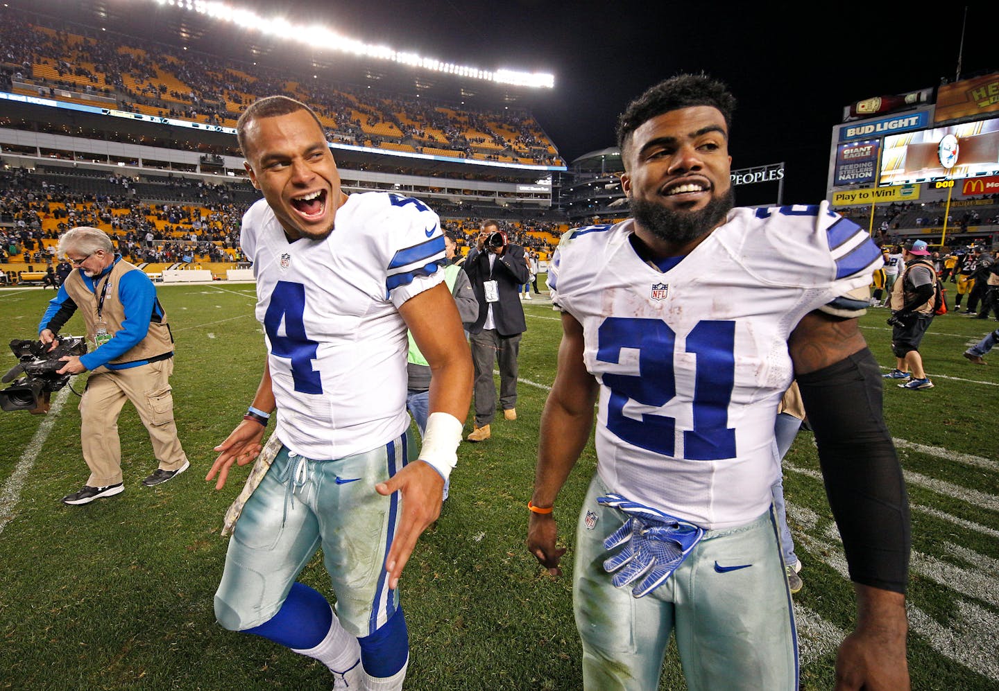 Dallas Cowboys running back Ezekiel Elliott (21) and quarterback Dak Prescott (4)