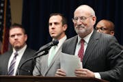 U.S. Attorney Andrew Luger, at podium, announced charges in March 2023 against 10 more people in the ongoing $250 million federal food aid fraud case 
