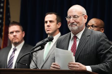 U.S. Attorney Andrew Luger, at podium, announced charges in March 2023 against 10 more people in the ongoing $250 million federal food aid fraud case 