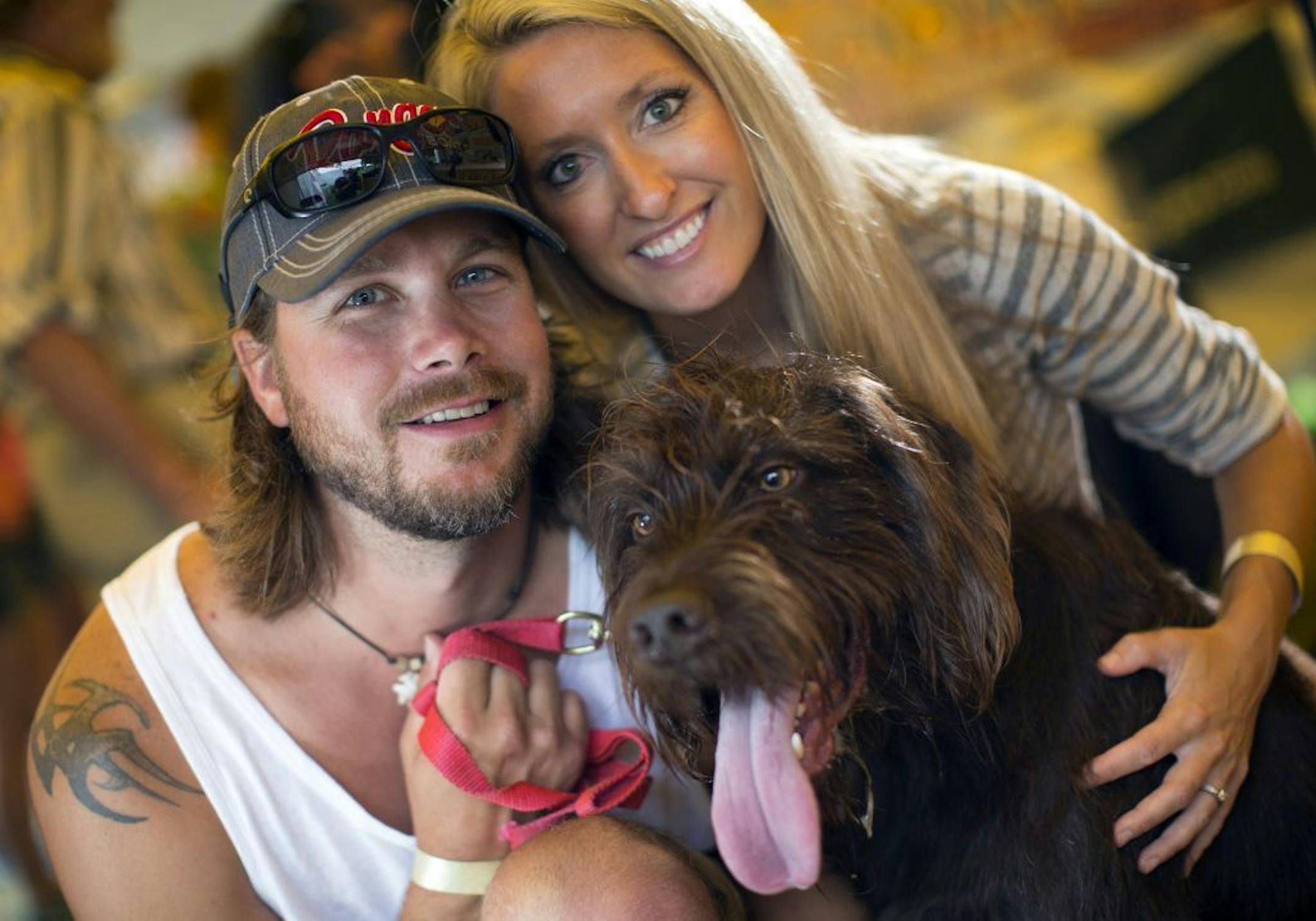 Mitch and Samantha Hackenmueller of Zimmerman with Kane, the poodle pointer.   The 2015 Gamefair has developed from one big circus tent to a mini State fair atmosphere over its 34 years. We photographed a slice of the fair through the people that have attending this year, some who have been all 34 years.  [ PHOTO BY TOM WALLACE ' tom.wallace2@comcast.net   owfair081415: Game Fair