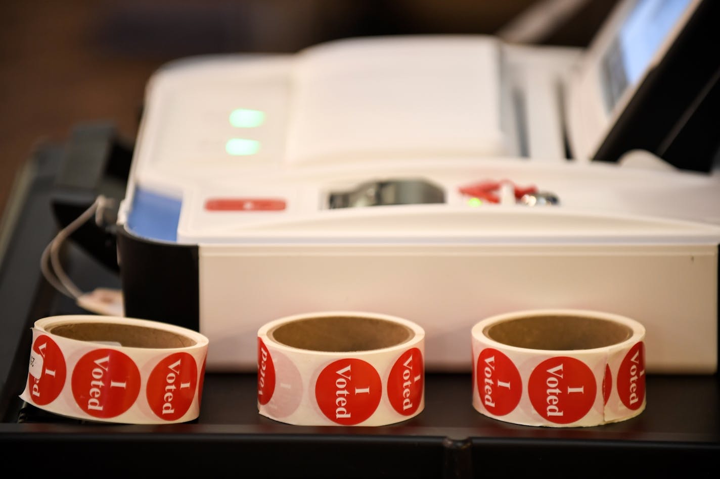 "I Voted" stickers sat beside a vote counting machine in Ravoux Hi-Rise in St. Paul Tuesday .