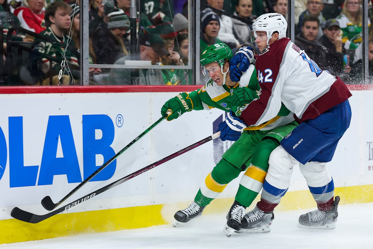 Wild left wing Matt Boldy, left, and Colorado defenseman Josh Manson competed for the puck during the first period Friday.