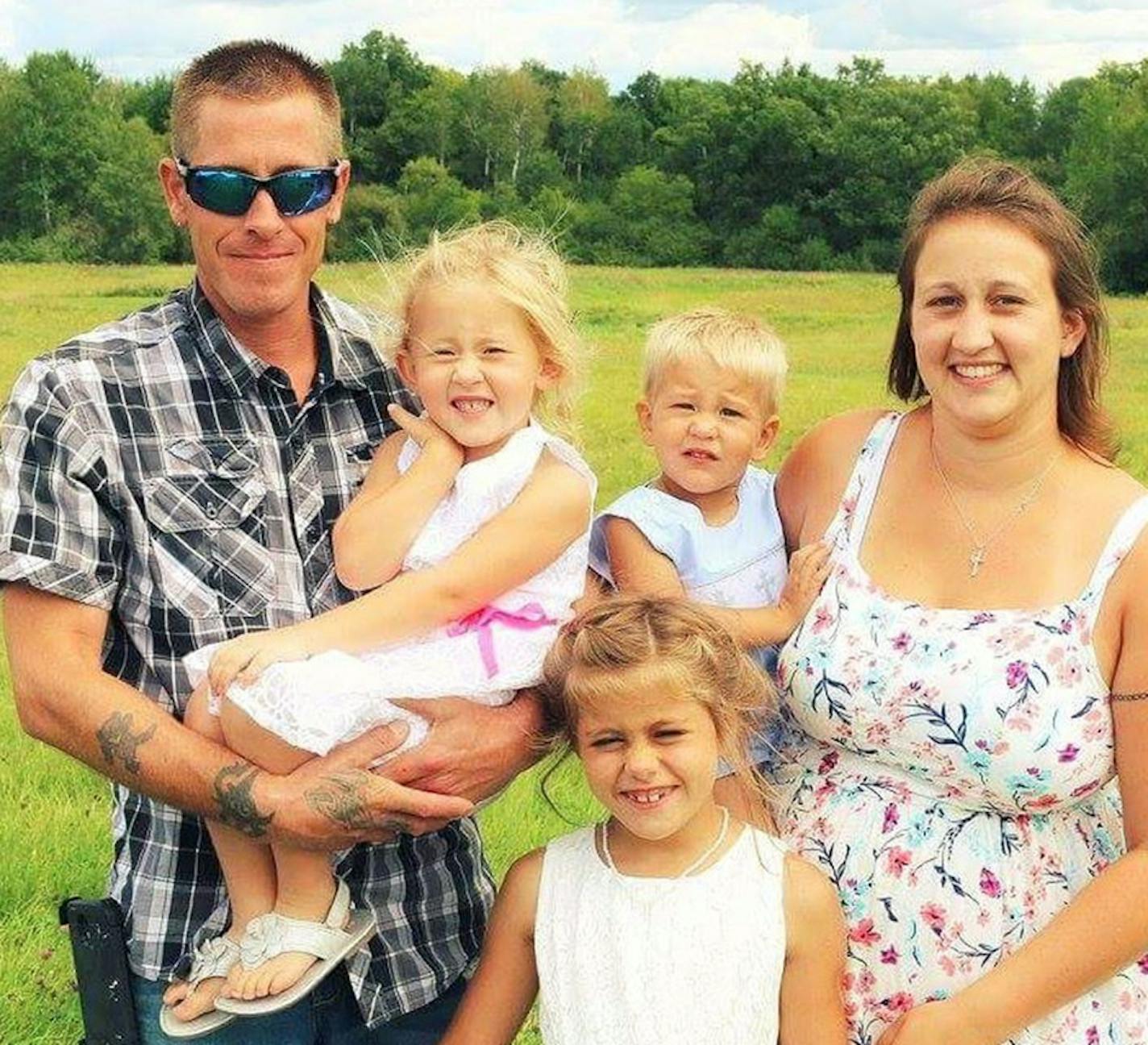 Eric Fryman, left, Annaliese, 5 (in Eric's arms) Jansen,3, held by Cari Mews, Kyra 9, in front. Fryman and the children are dead after their kayak capsized off Lake Superior's Apostle Islands. Mews survived.