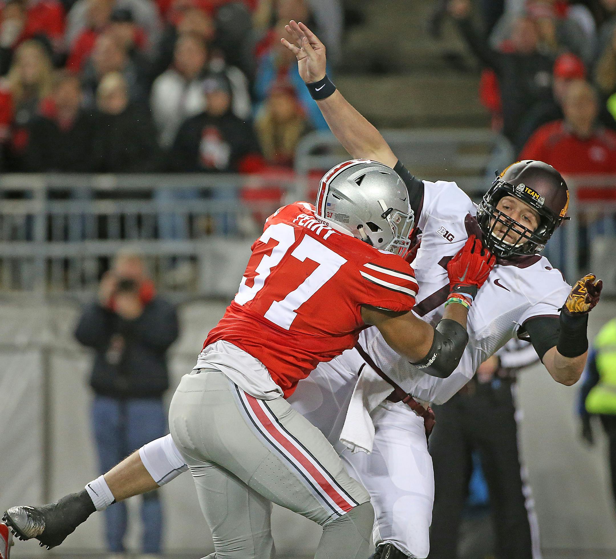 Ohio State's linebacker Joshua Perry tackled Minnesota's quarterback Mitch Leidner just as he threw an interception for an Ohio touchdown in the second quarter the Minnesota Gophers took on the Ohio State Buckeyes at Ohio Stadium, Saturday, November 7, 2015 in Columbus, OH. ] (ELIZABETH FLORES/STAR TRIBUNE) ELIZABETH FLORES &#x2022; eflores@startribune.com