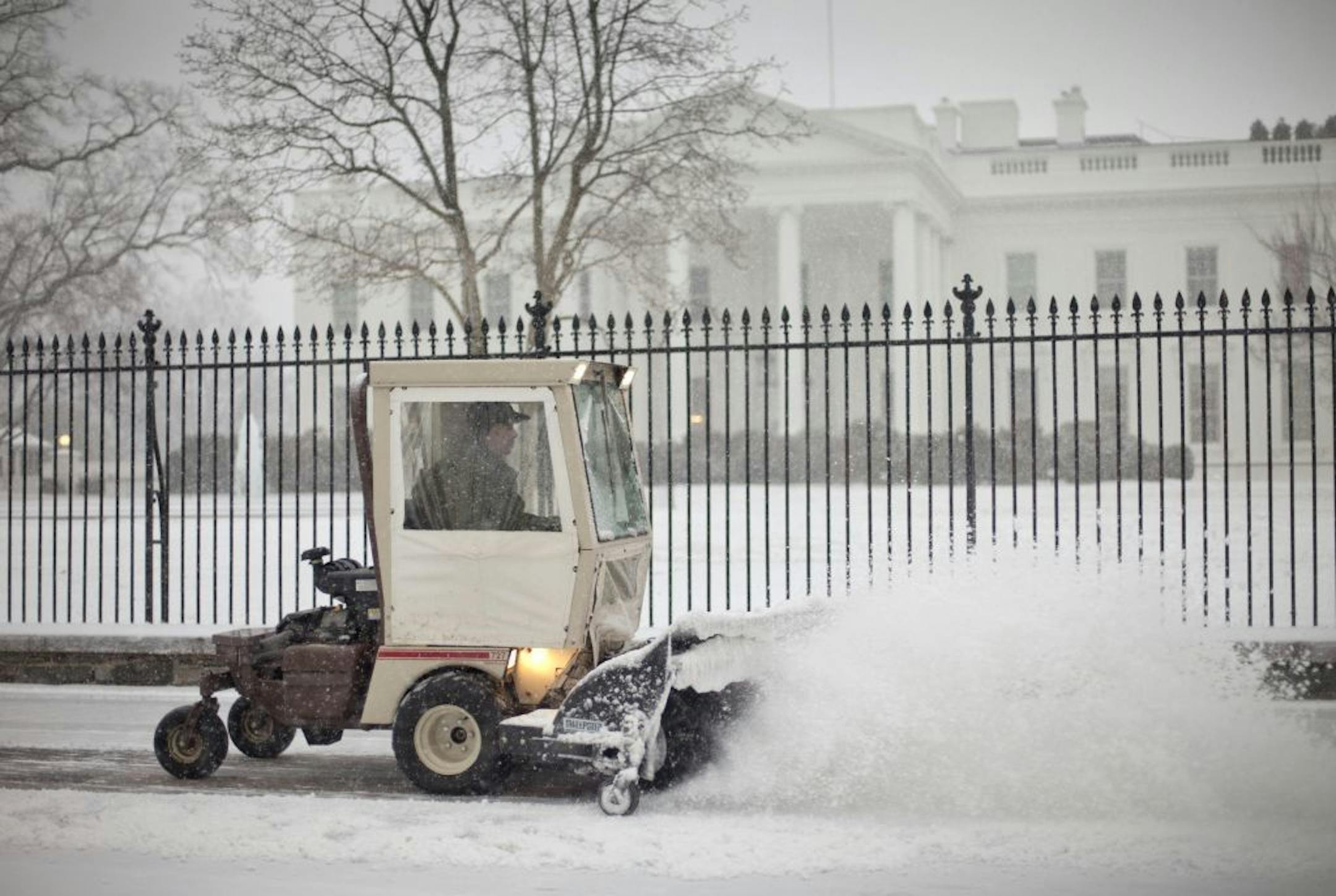 The sidewalk in front of the White House in Washington is cleared of snow, Monday, March 3, 2014.