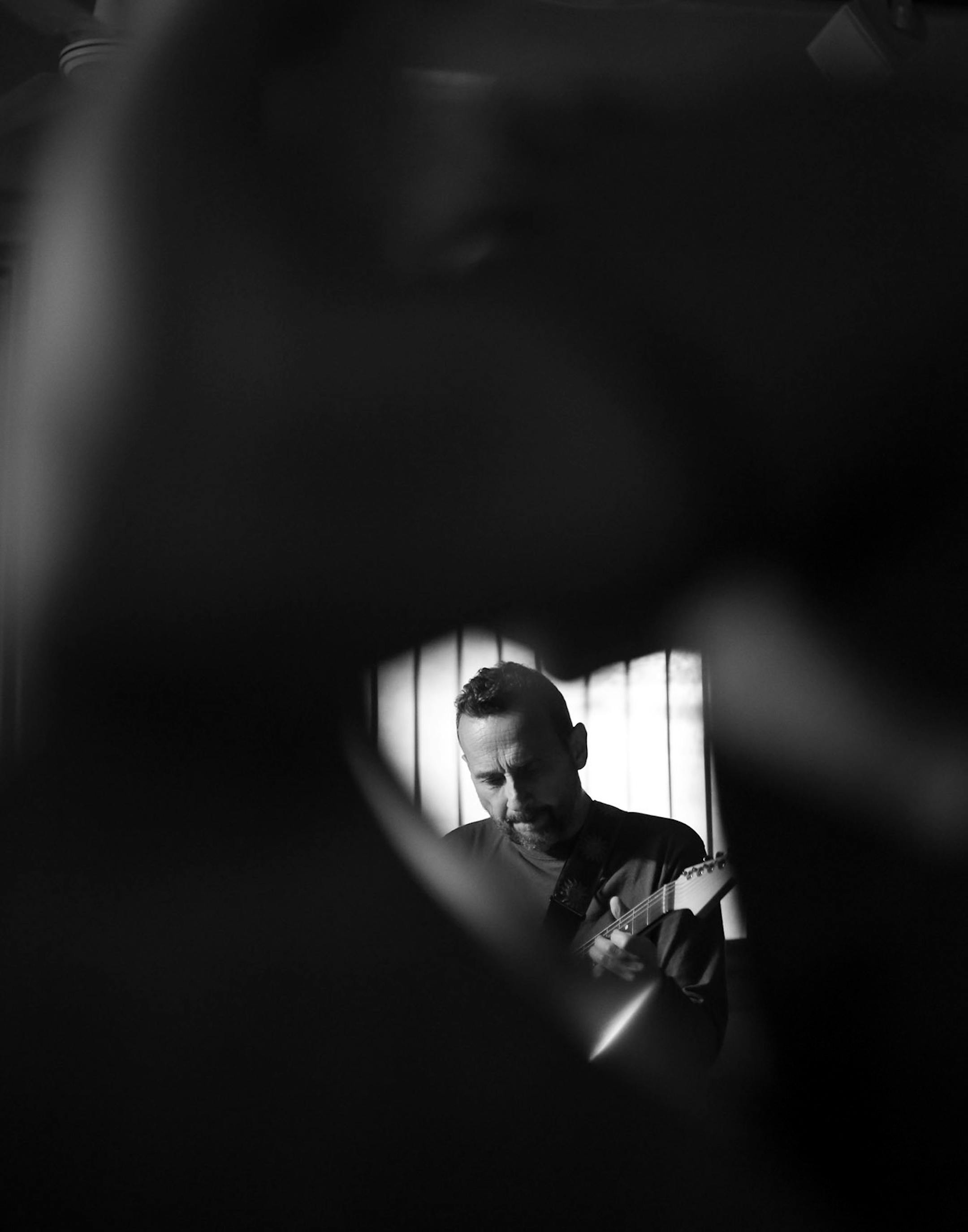 Guitarist Dean Magraw of Red Planet, framed through the bass of Chris Bates as they performed their late set at Khyber Pass earlier this month.