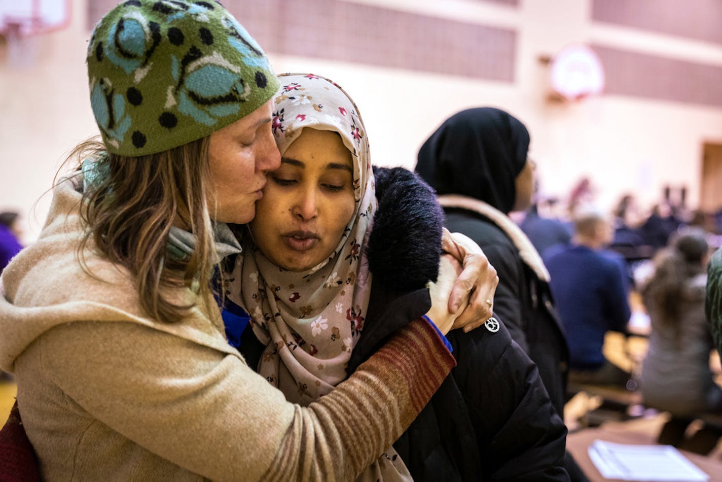 Asha Farah, right, got emotional while speaking about potentially having to move her children from Clara Barton Open School. Fellow Clara Barton parent Jerri Clark Wagner helped calm her during a meeting at the school.