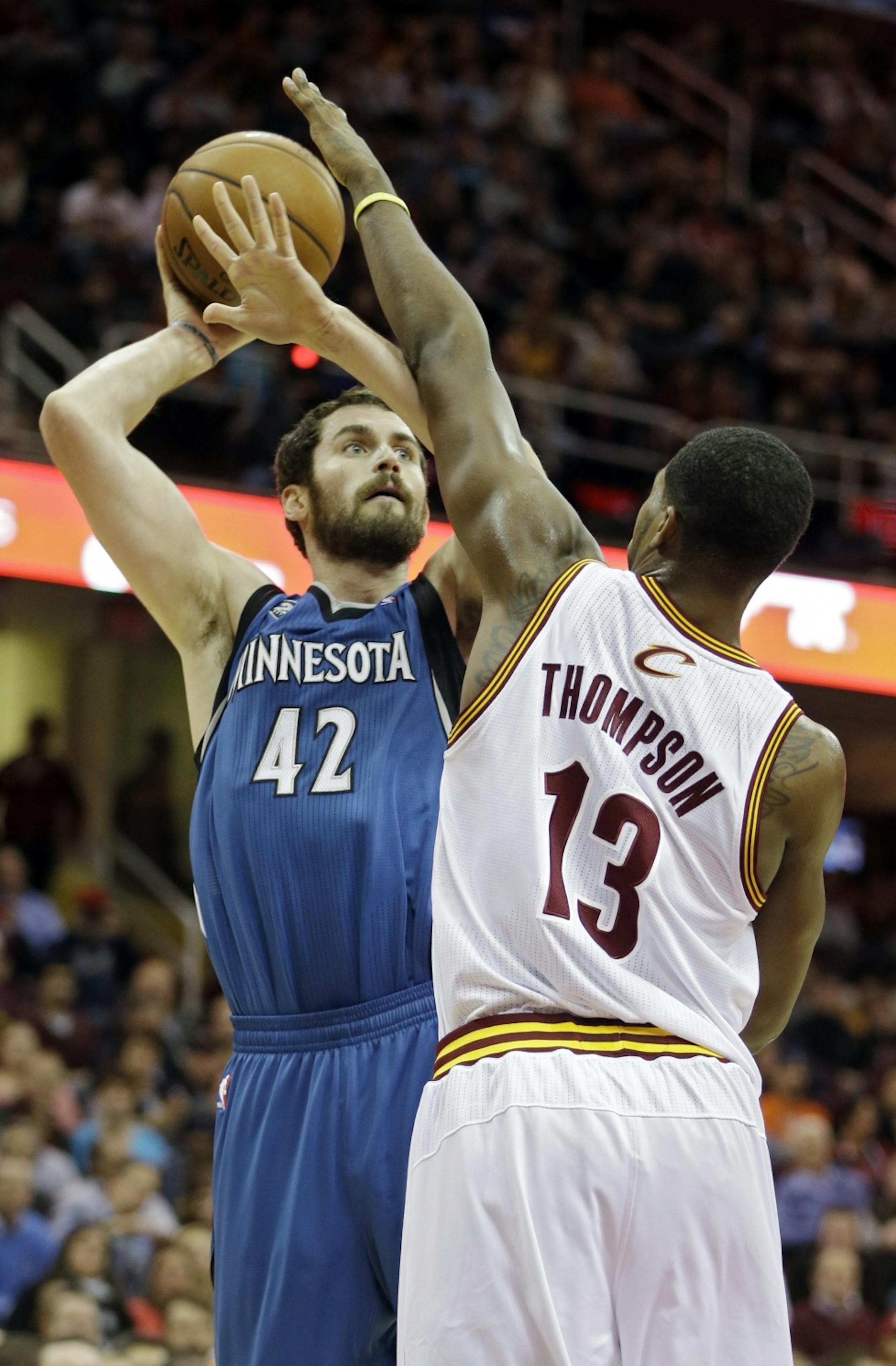 Minnesota Timberwolves' Kevin Love (42) shoots against Cleveland Cavaliers' Tristan Thompson (13) in the first quarter of an NBA basketball game Monday, Nov. 4, 2013, in Cleveland.