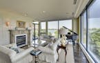 The condo's living room combines traditional touches with modern elements and delivers a panoramic view of Lake Calhoun.