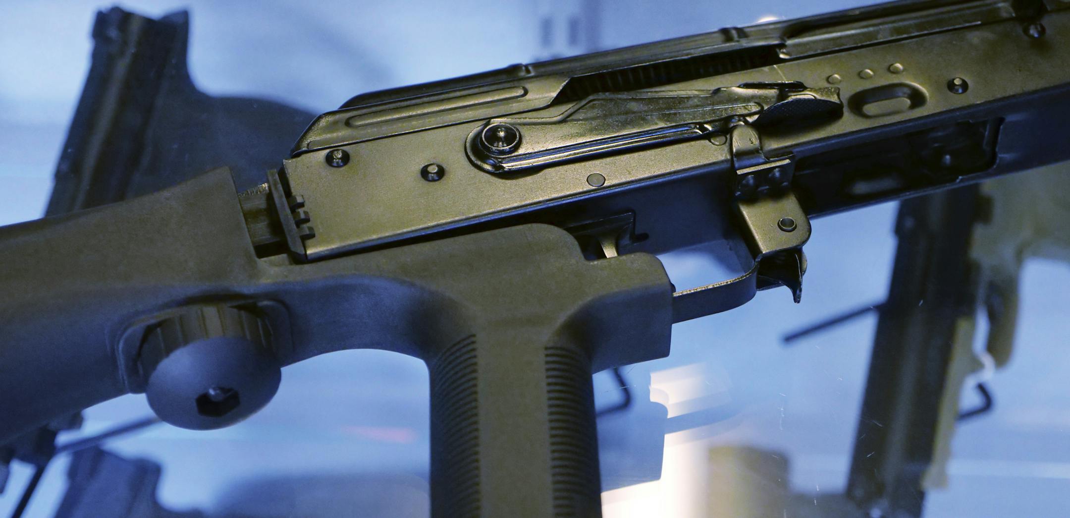 FILE - In this Oct. 4, 2017 file photo, a little-known device called a "bump stock" is attached to a semi-automatic rifle at the Gun Vault store and shooting range in South Jordan, Utah. The Trump administration is moving to officially ban bump stocks, which allow semi-automatic weapons to fire rapidly like automatic firearms. A senior Justice Department official said Tuesday bump stocks will be banned under the federal law that prohibits machine guns. It will take effect in late March. (AP Phot