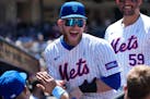 The Mets' Harrison Bader celebrates scoring on Pete Alonso's home run in the first inning against the Padres on Sunday in New York.