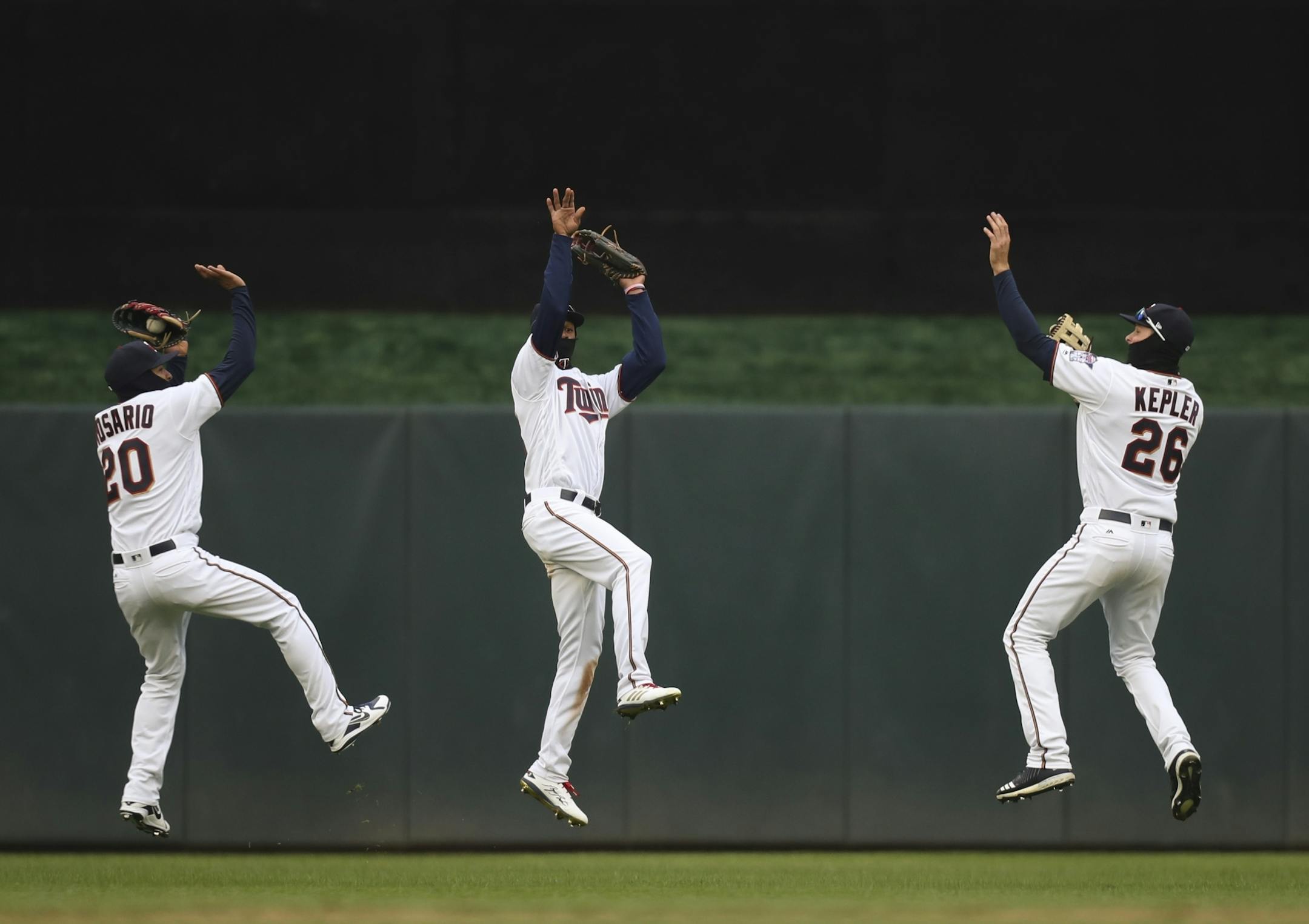 Twins left fielder Eddie Rosario (20), center fielder Byron Buxton, and right fielder Max Kepler (26) celebrated the Twins win with synchronized jump shots.