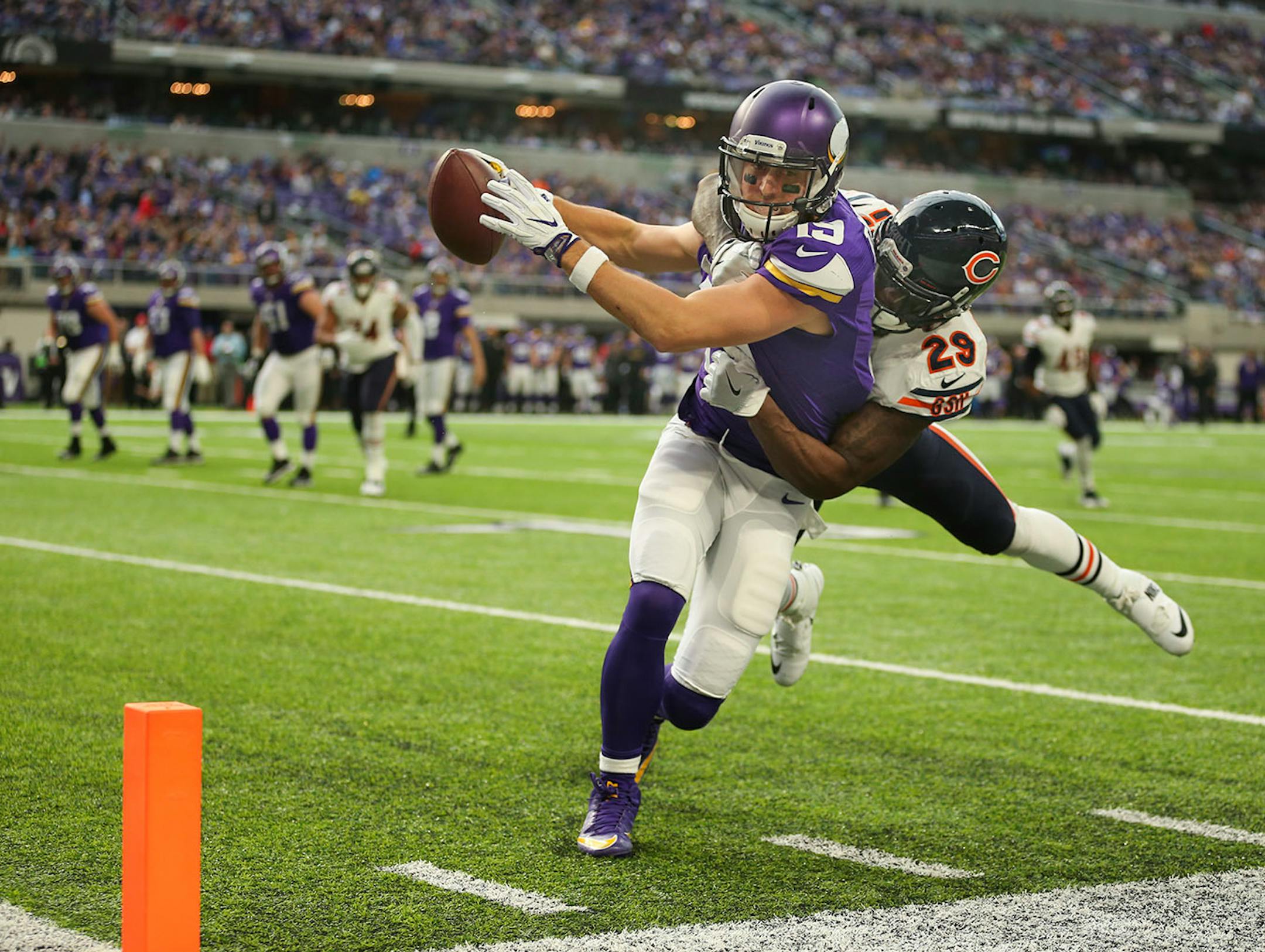 Vikings wide receiver Adam Thielen (19) had Chicago Bears strong safety Harold Jones-Quartey (29) draped over his back while he lunged for the endzone on a seven yard reception that brought the ball to the one yard line in the second quarter.