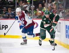 Minnesota Wild forward Vinni Lettieri (10) looks for a teammate to pass to after winning the puck from Colorado Avalanche center Fredrik Olofsson (22)